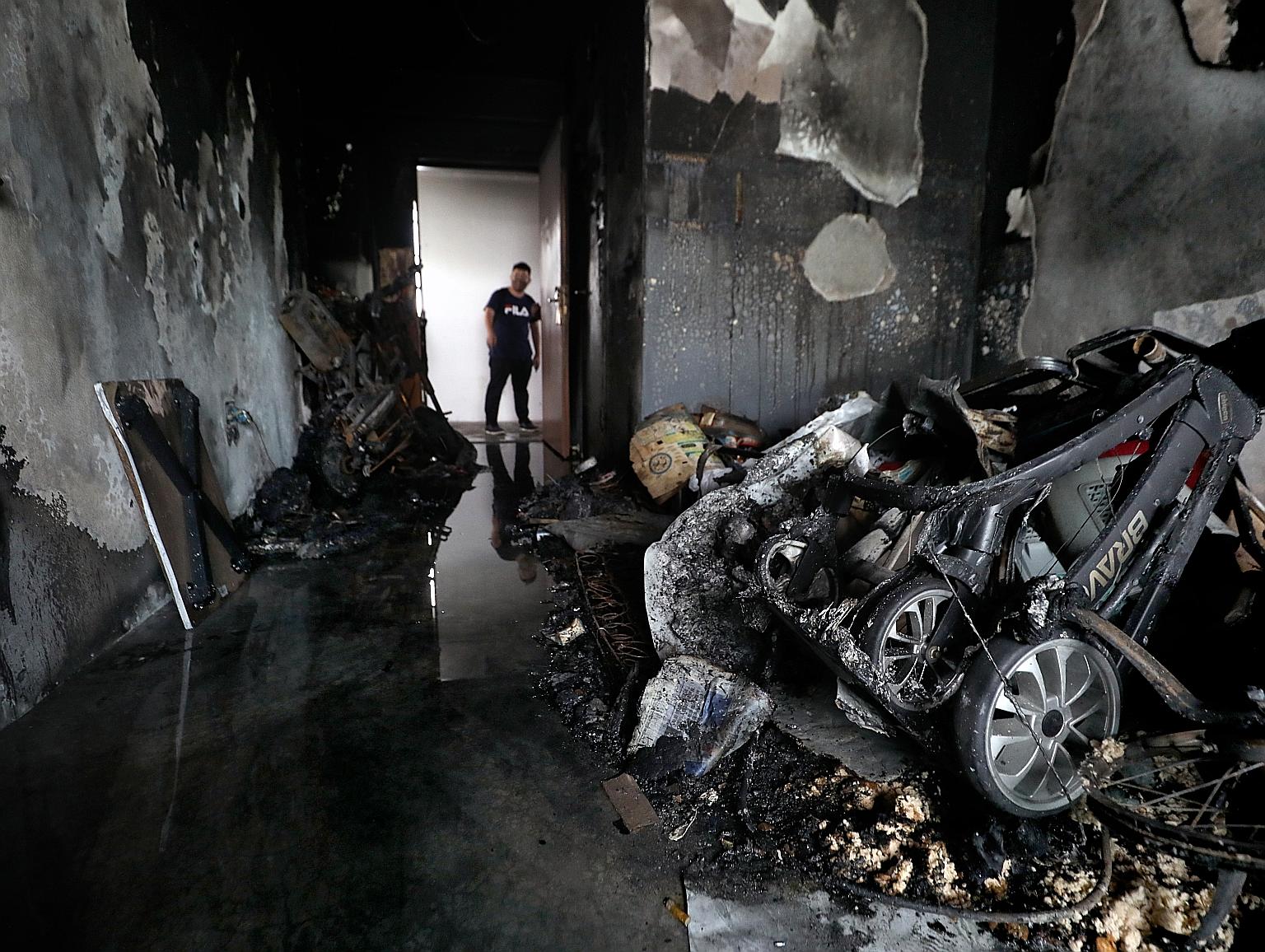 When the Singapore Civil Defence Force arrived at the scene of the fire in Yishun yesterday, officers found one occupant in the bedroom and the other in the toilet. Both had to be carried out. PHOTO: LIANHE ZAOBAO
