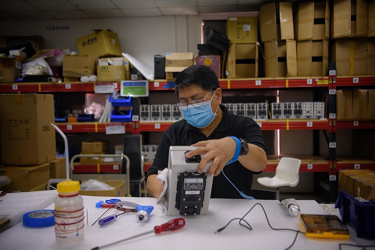 Mr Abdul Hamid Abdul Ghani, 59, is one of eight workers seconded to Hope Technik where they assemble the engineering firm's temperature assessment systems - which are used for temperature screening in public places - and carry out quality control che