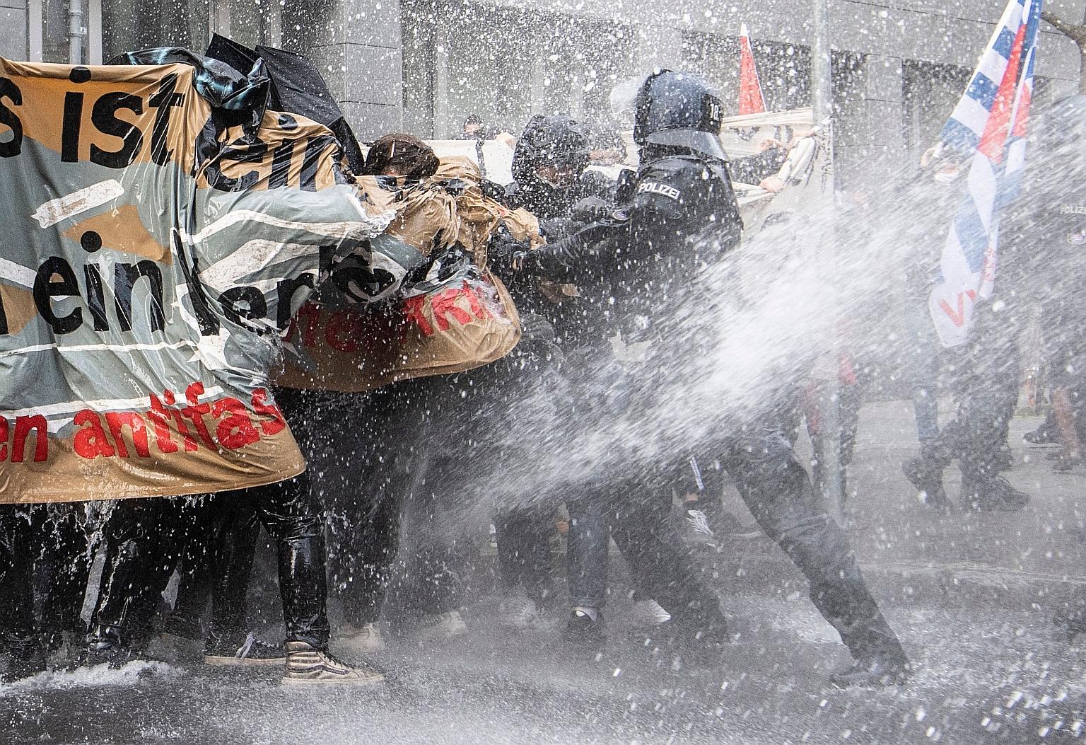 German police using a water cannon to disperse anti-lockdown protesters in Frankfurt city on Saturday after they were found to be not observing social distancing rules.