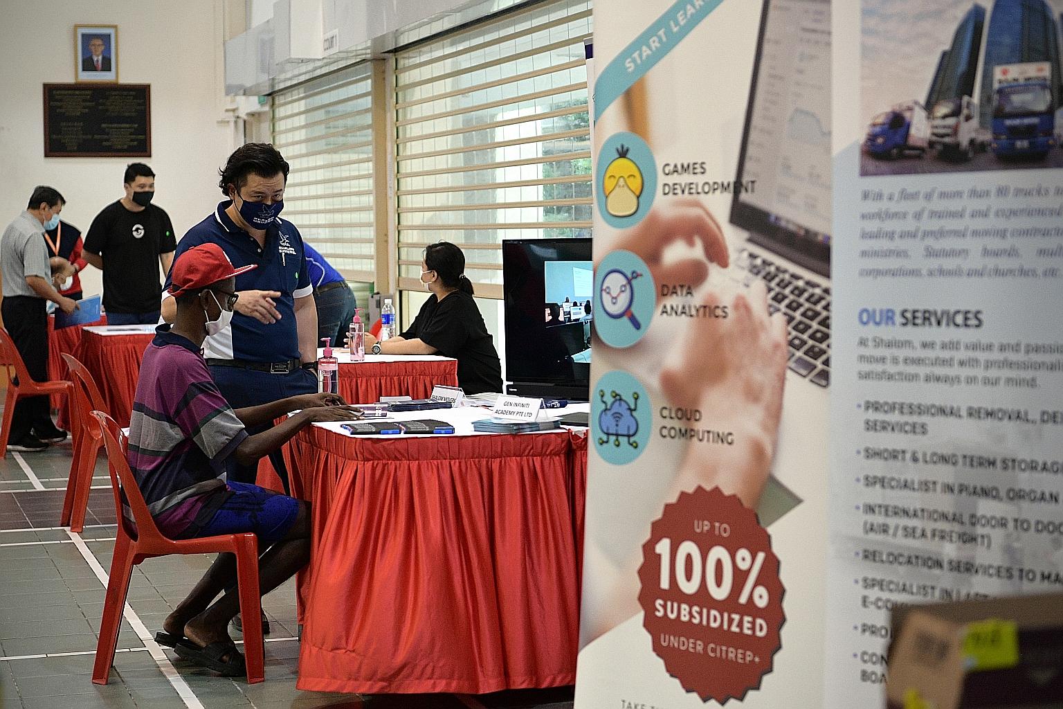 A job applicant (in purple) at Hong Kah North Community Club yesterday. The jobs available at the fair, which runs till tomorrow, range from waste collection truck captain to recycling facility operations executive.