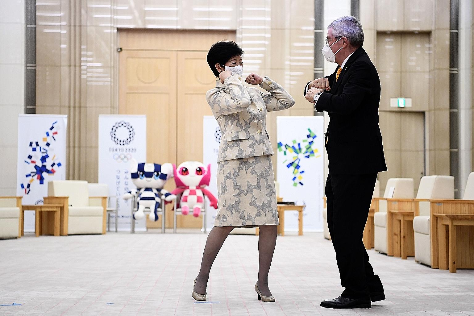 Tokyo Governor Yuriko Koike bumping elbows with IOC chief Thomas Bach before their meeting. He is visiting Japan for discussions on the Olympics.