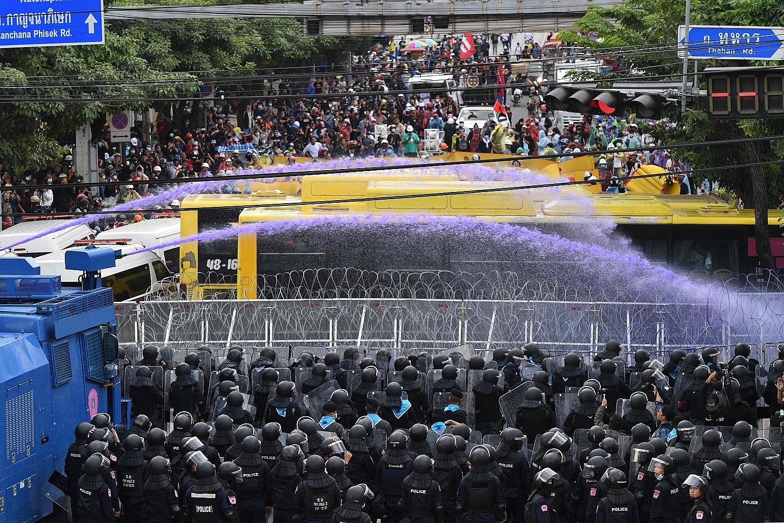 Thailand's riot police yesterday sprayed water cannon at pro-democracy activists rallying near Parliament as lawmakers began to discuss a road map for amending the nation's Constitution. Protesters tried to breach concrete barricades and barbed wire 