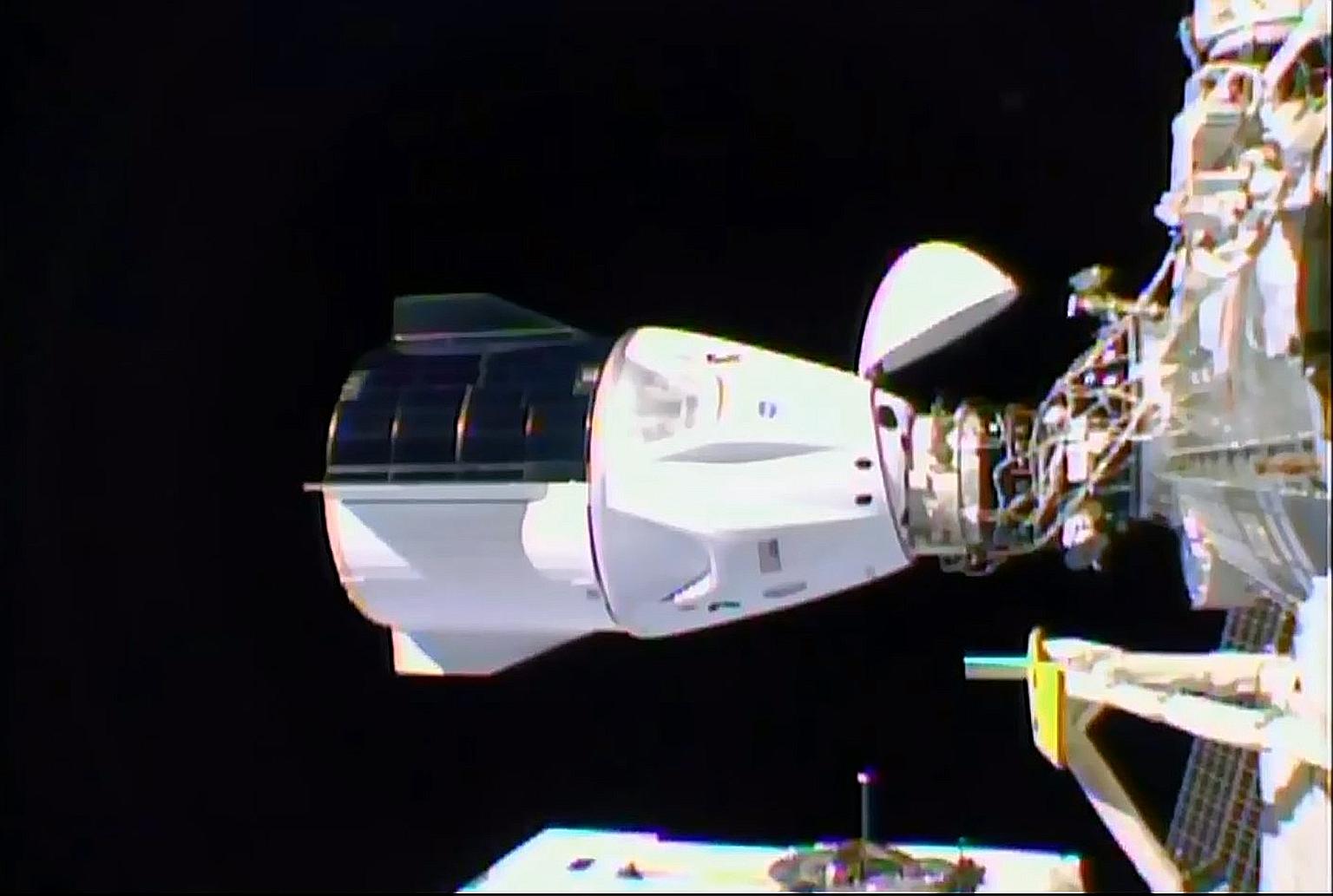 The SpaceX Crew Dragon (left) docked to the International Space Station on Monday. This is Nasa's first full-fledged mission ferrying a crew into orbit on a privately-owned spacecraft. PHOTO: AGENCE FRANCE-PRESSE