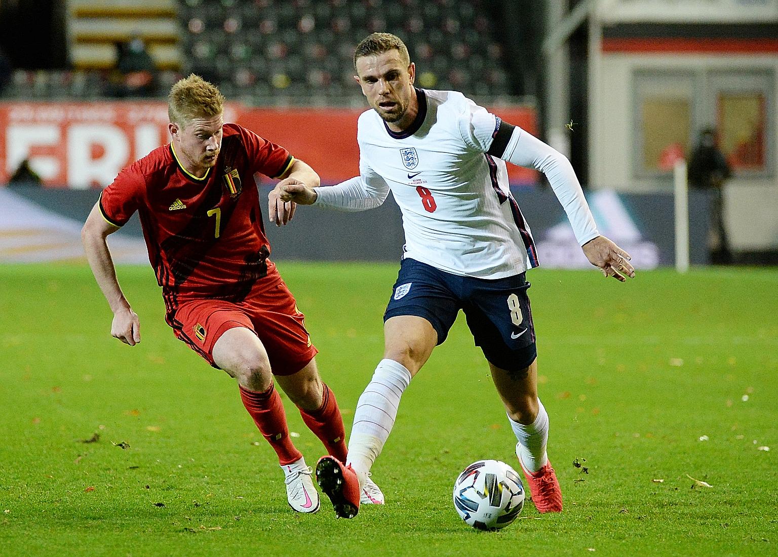 England's Jordan Henderson holding off Belgium's Kevin de Bruyne in their Nations League match last Sunday. The Liverpool man will miss today's clash against Iceland owing to injury.