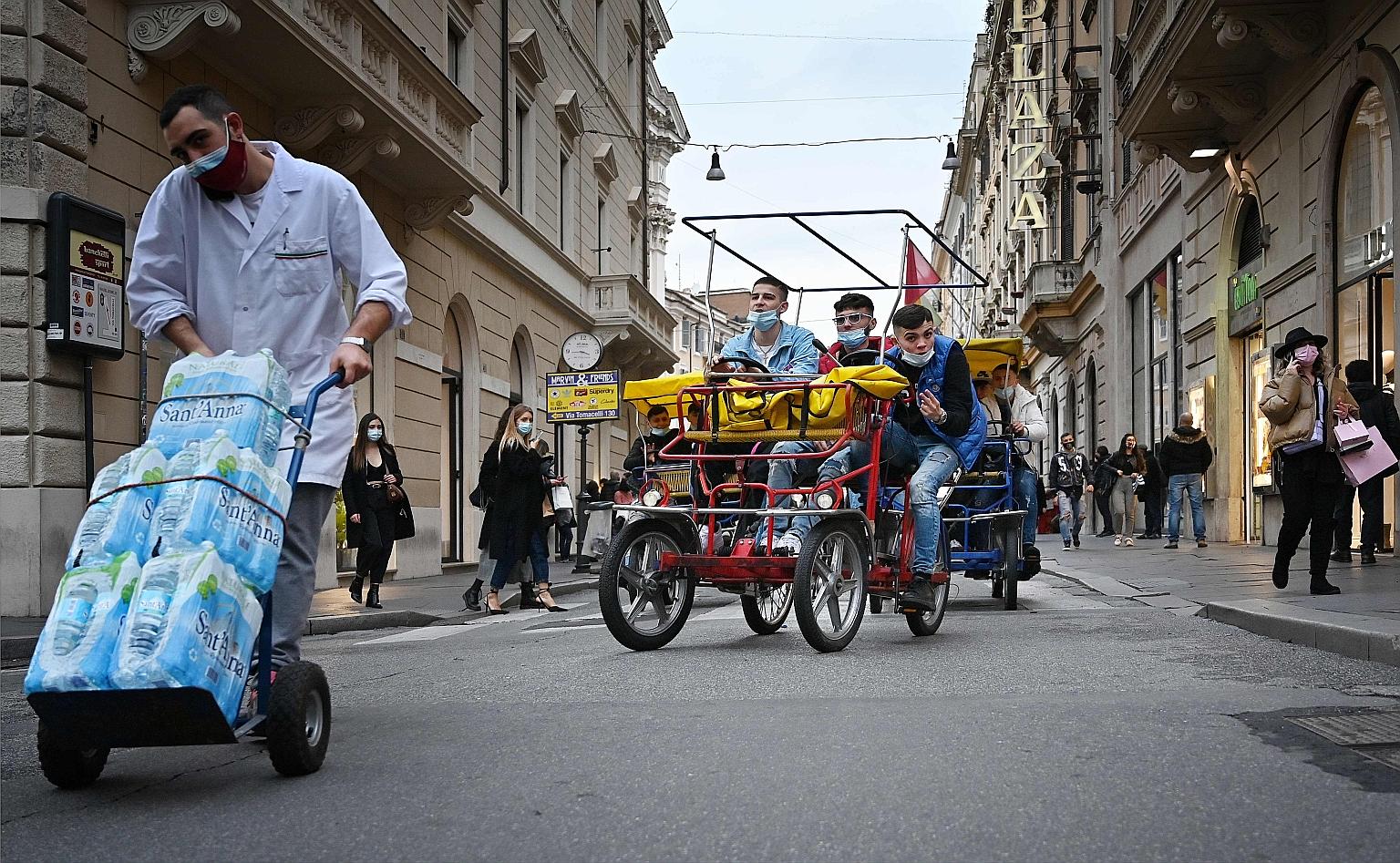 Young people out on a street in Rome. The pandemic appears to have reinforced the younger generation's resolve and vision to build a better future, a survey showed. PHOTO: AGENCE FRANCE-PRESSE