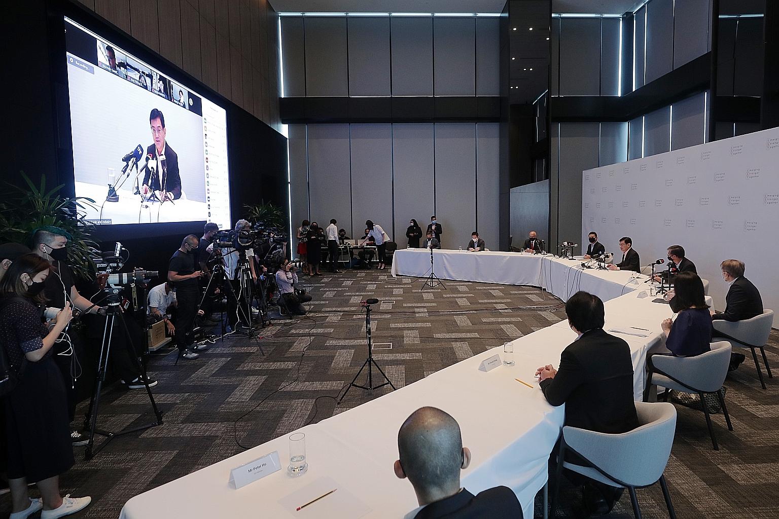 Deputy Prime Minister Heng Swee Keat (centre), chairman of the Future Economy Council, which oversees the task force, speaking to the media yesterday, with members of the Emerging Stronger Taskforce.