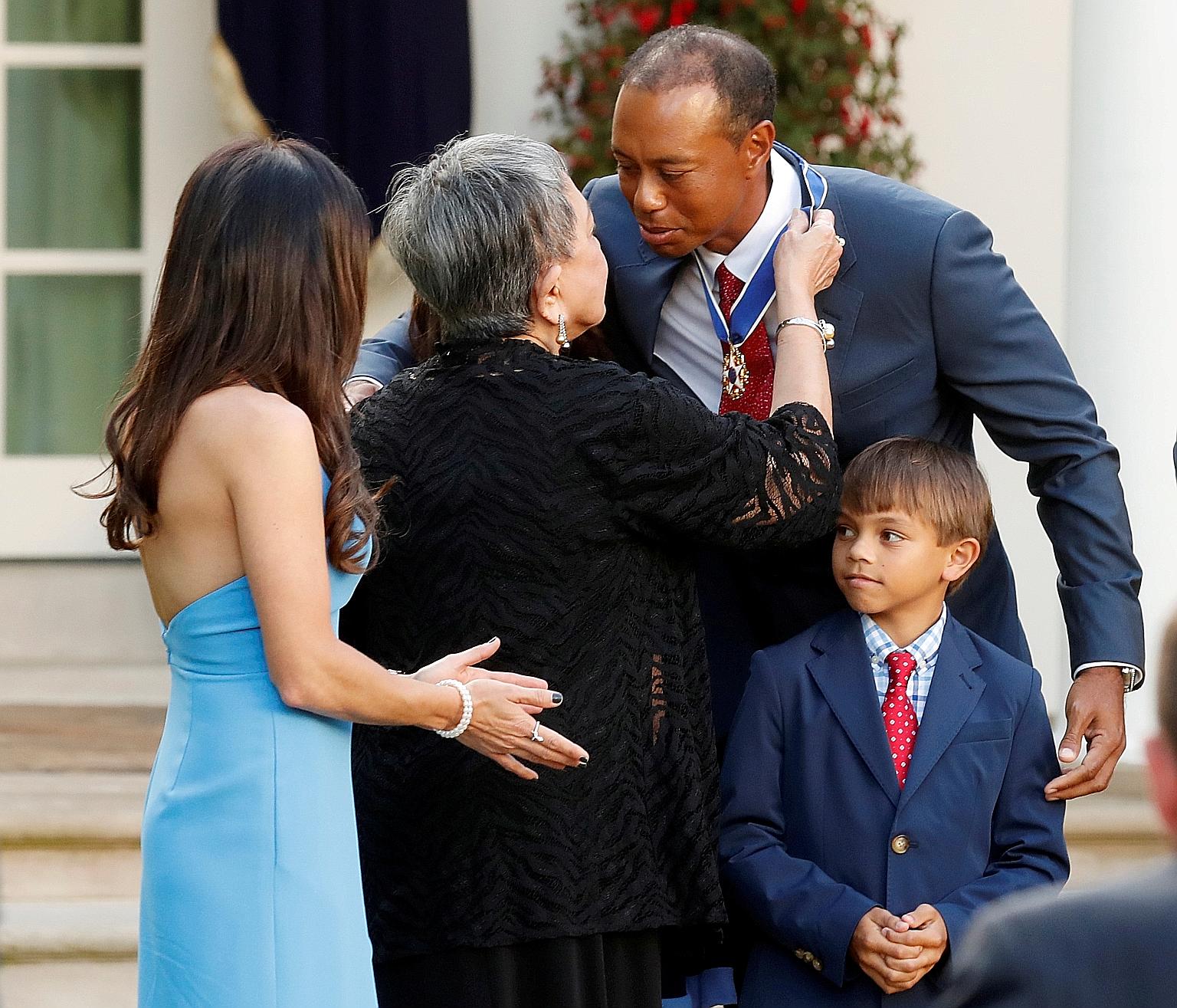 Tiger Woods is embraced by his mother Kultida after being presented with the Presidential Medal of Freedom, the US' highest civilian honour, in May last year as his son Charlie looked on in the White House Rose Garden.