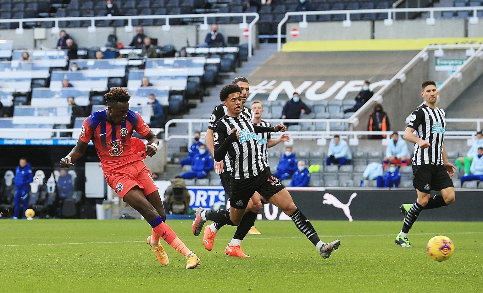 Chelsea's Tammy Abraham sealing the three points for his team in yesterday's 2-0 win at Newcastle. It was the Blues' third straight win in the Premier League, provisionally moving them to first in the table.
