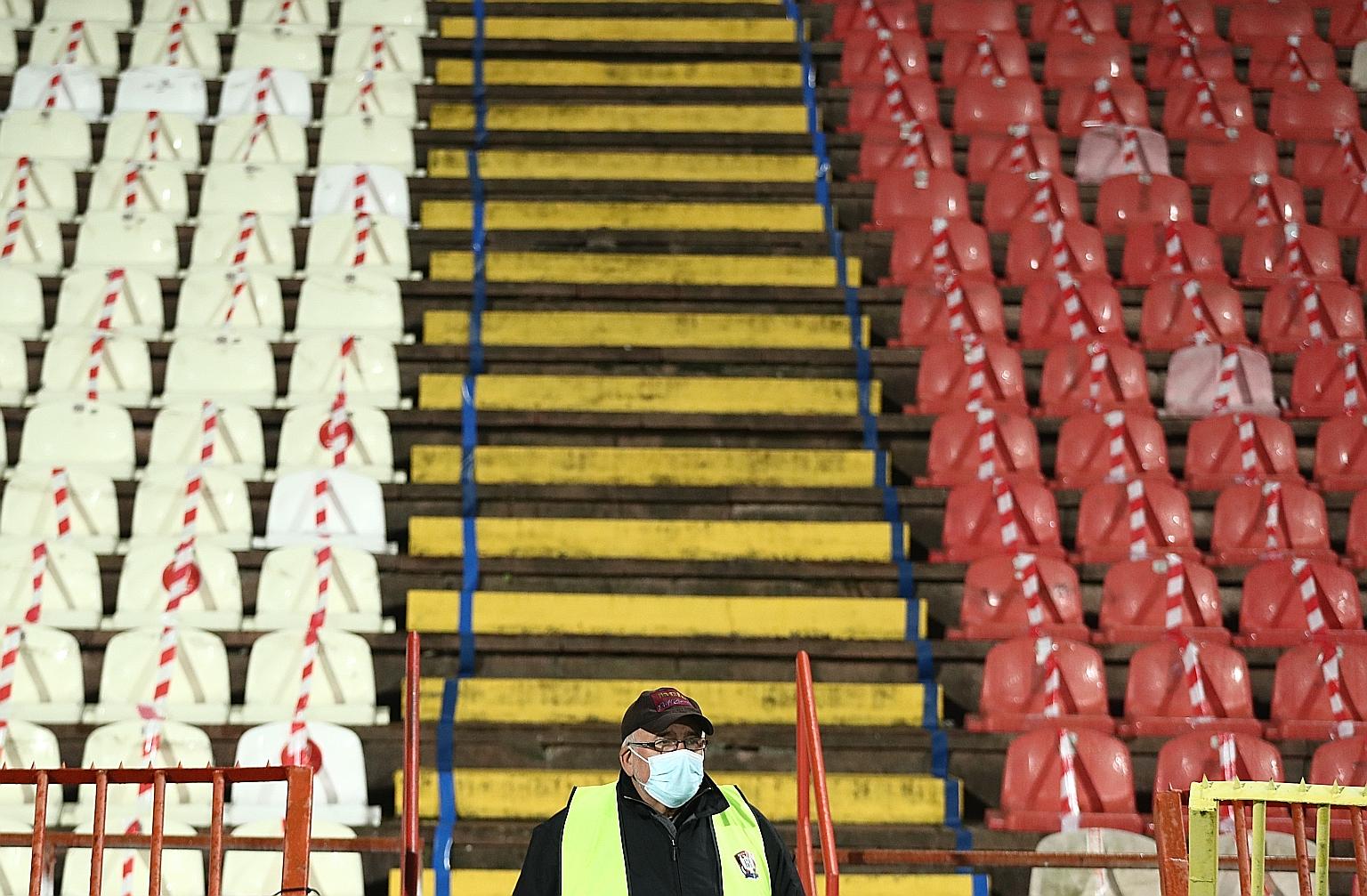 A staff member wearing a mask before Scotland's football team faced Serbia in Belgrade for a place in the European Championship. A rare bright spot from the international break was Scotland ending a 22-year wait to qualify for a major tournament, as 
