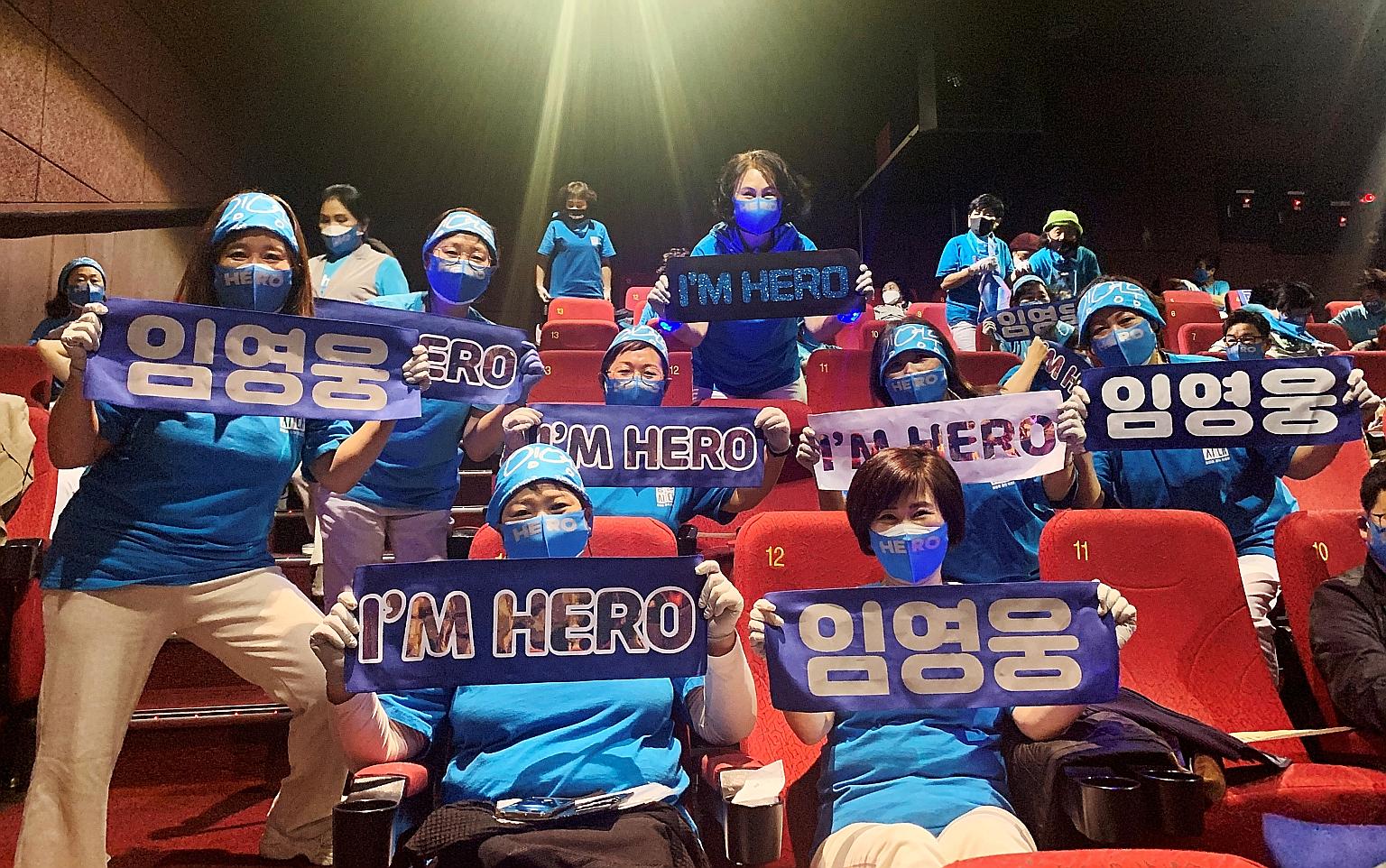 Fans of South Korean singer Lim Young-woong posing for photographs with banners bearing his name before watching Mr Trot: The Movie, at a theatre in Gunpo, South Korea, last month.