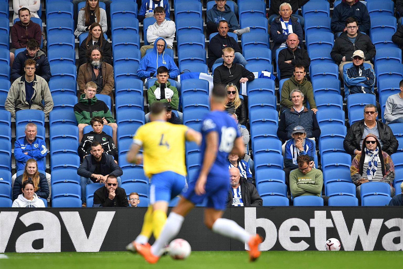 Socially distanced fans watching a friendly between Brighton and Chelsea at the Amex Stadium in August.