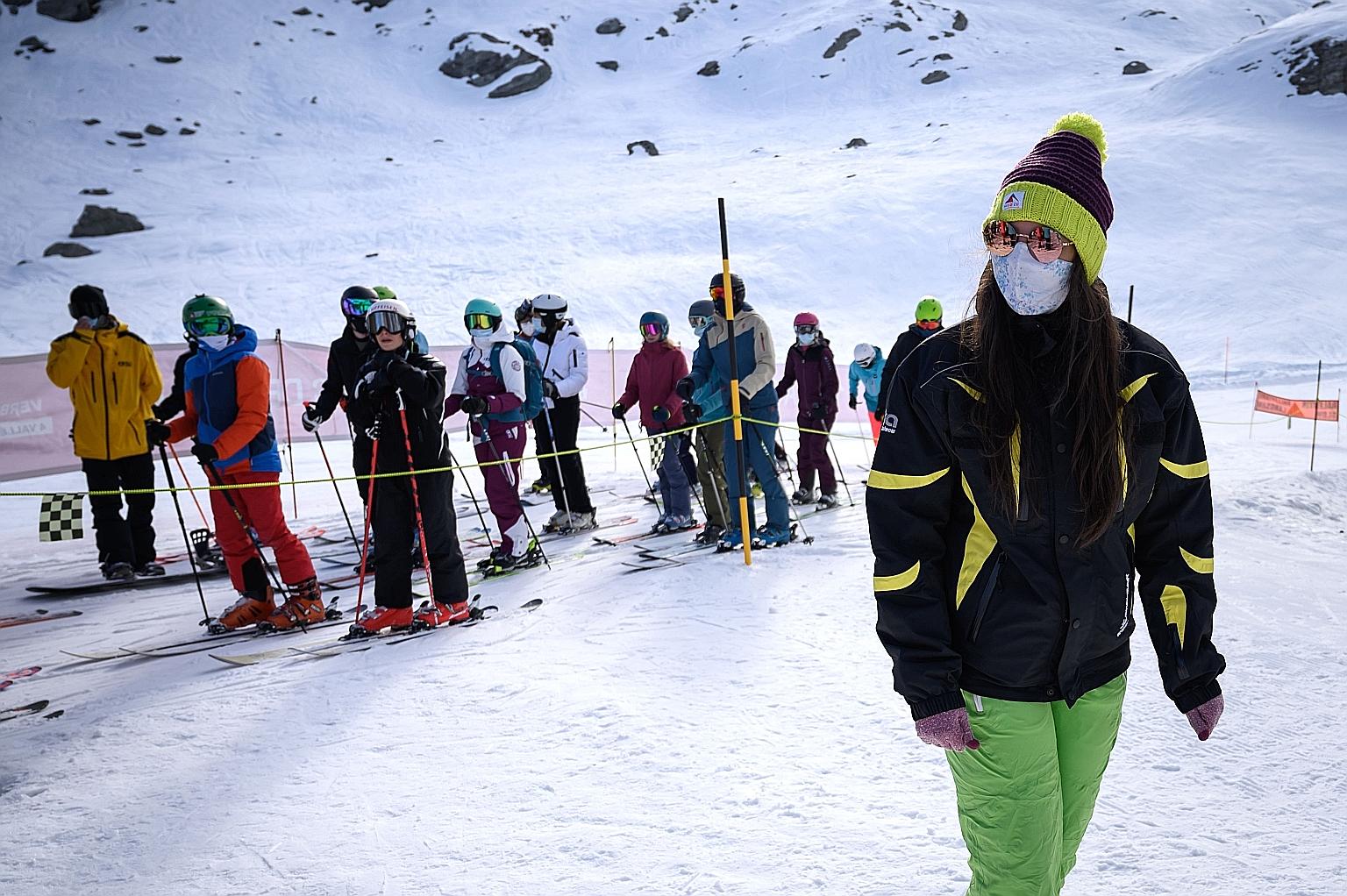 Some skiers at the Alpine resort in Verbier, Switzerland wear masks as they queue for the ski lift. Resorts in Italy and France are set to stay shut.