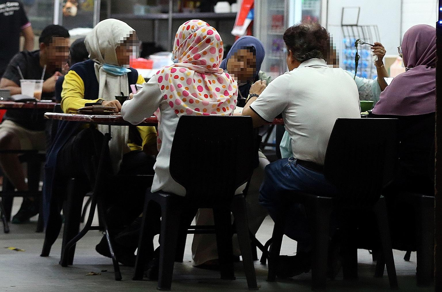 In this photo taken at a late-night eatery on Oct 10, a man who is allegedly the leader of a deviant religious group is seen with five women who have been described by the group's former followers as the man's spiritual wives. Among his teachings, th