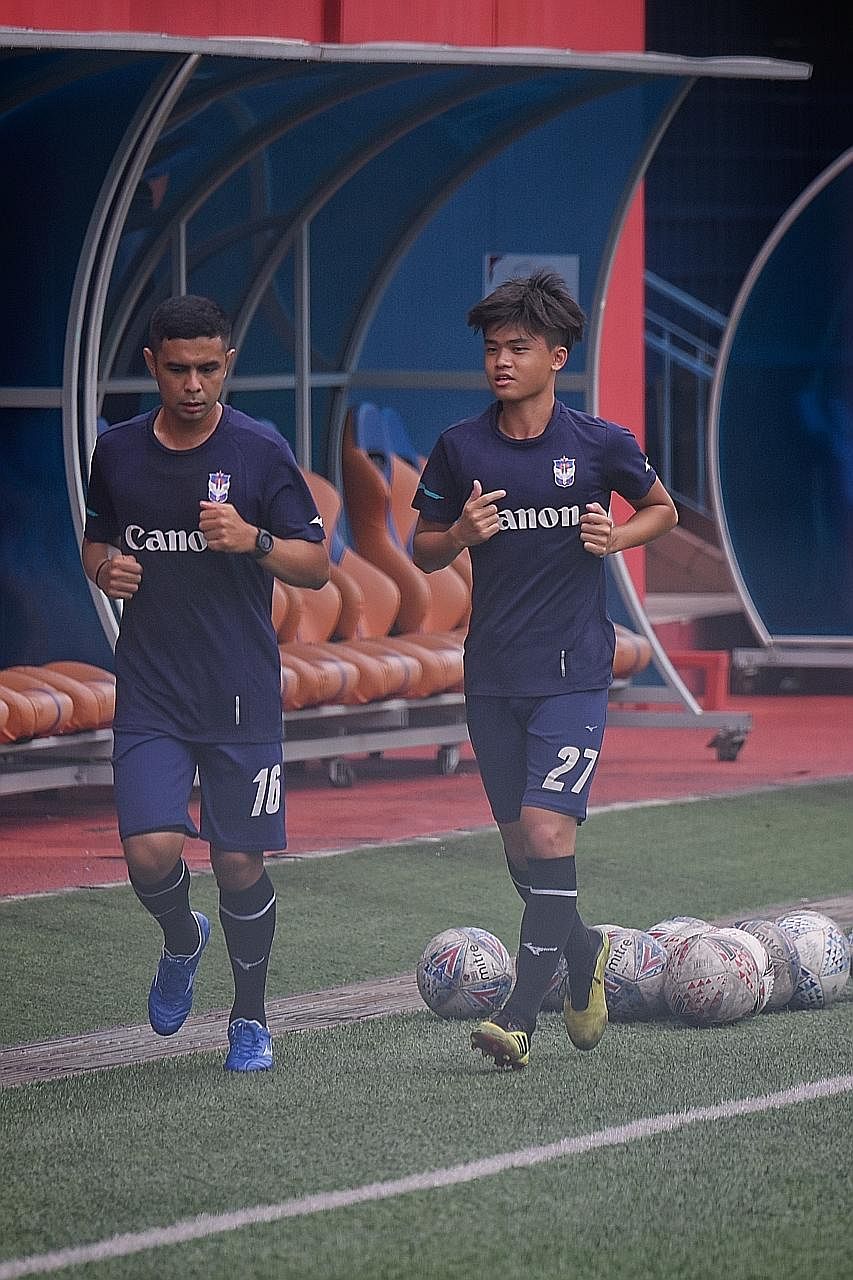 Albirex Niigata's veteran Fairoz Hasan and teenager Ong Yu En training at Jurong East Stadium on Friday. Albirex are chasing their fourth SPL title, while closest rivals Tampines are aiming for their sixth.
