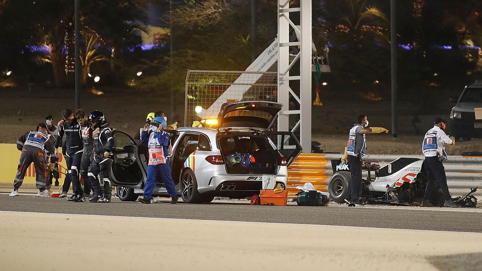 Romain Grosjean is assisted by medical crew after escaping from his blazing car following a horrific first-lap crash at Formula One's Bahrain Grand Prix yesterday. His car split in two and burst into flames. The French driver's Haas skewed into a bar
