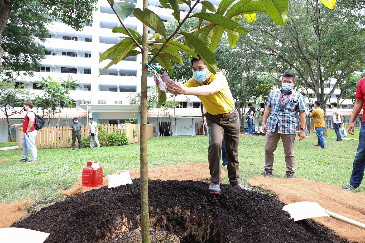 Deputy Prime Minister Heng Swee Keat planting a tree at Block 30, Bedok South Avenue 2, yesterday. He unveiled the blueprint for the East Coast Sustainability and Greenery Plan on Facebook Live.