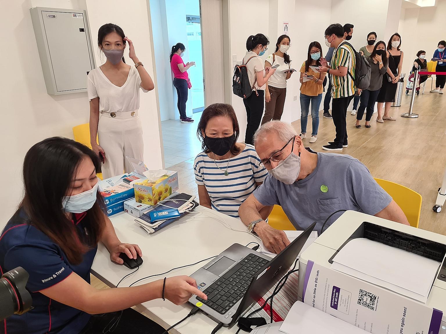 Taxi driver Ng Beng Lam, 72, and his wife Ong Choon Hwa, 68, were the first to make a booking at the Klook and UOB Travel Planners counter at Tampines East CC yesterday.