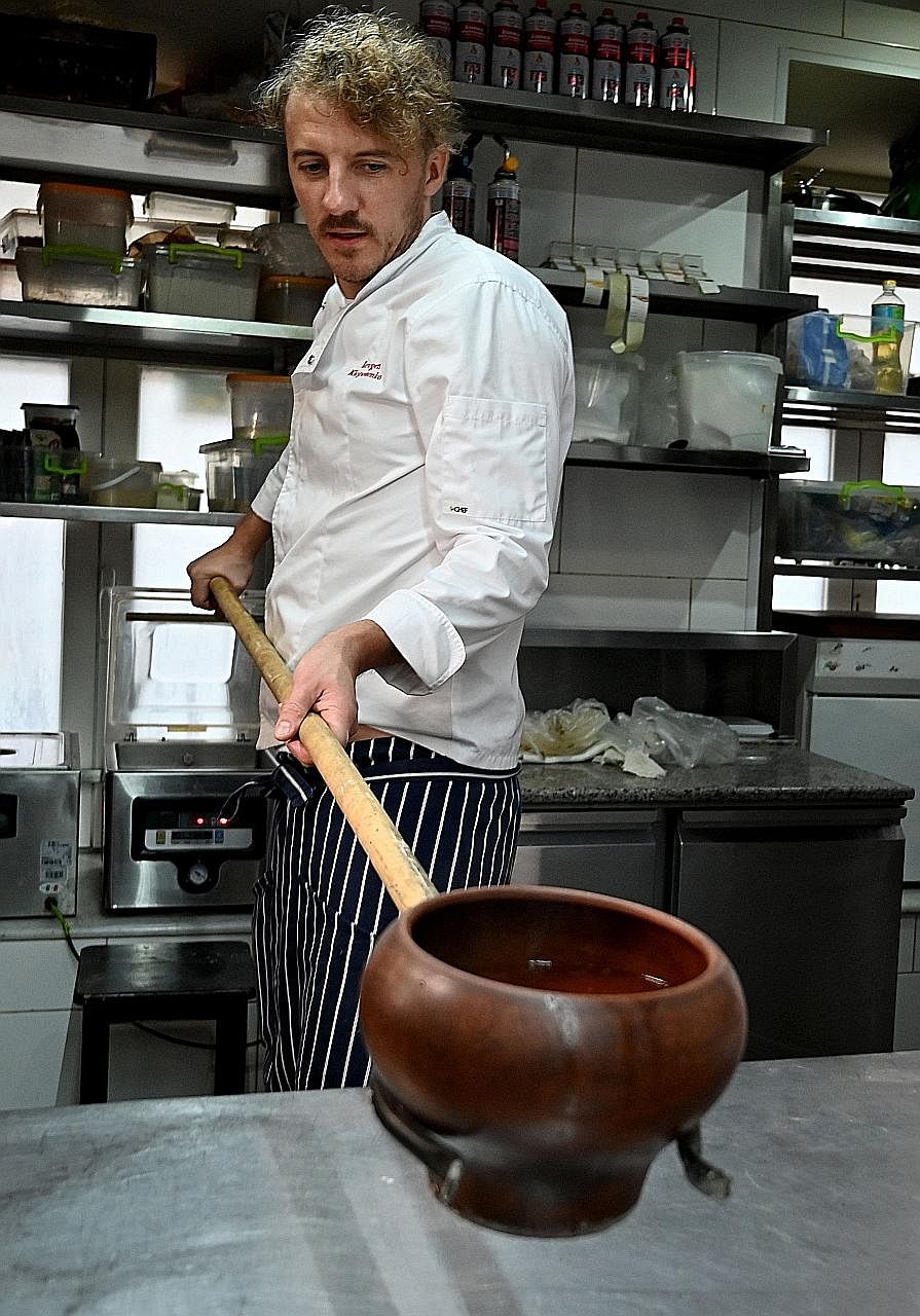 Left: Ukrainian chef Ievgen Klopotenko cooking borscht, a traditional beetroot and cabbage dish, in his restaurant in Kiev last month. The chef, fed up with how restaurants globally were referring to borscht as Russian soup, convinced Ukraine's cultu