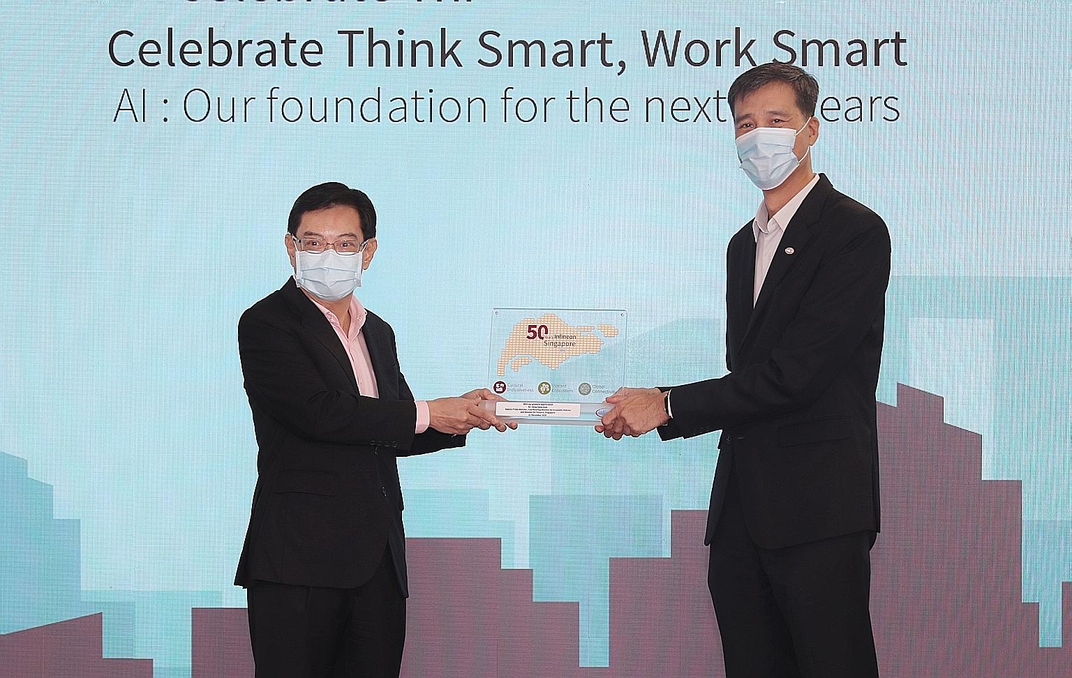 Deputy Prime Minister Heng Swee Keat receiving a plaque from Infineon Technologies Asia Pacific president and managing director Chua Chee Seong yesterday, at a ceremony to mark the company's 50th year in Singapore. Mr Heng said Infineon is a role mod