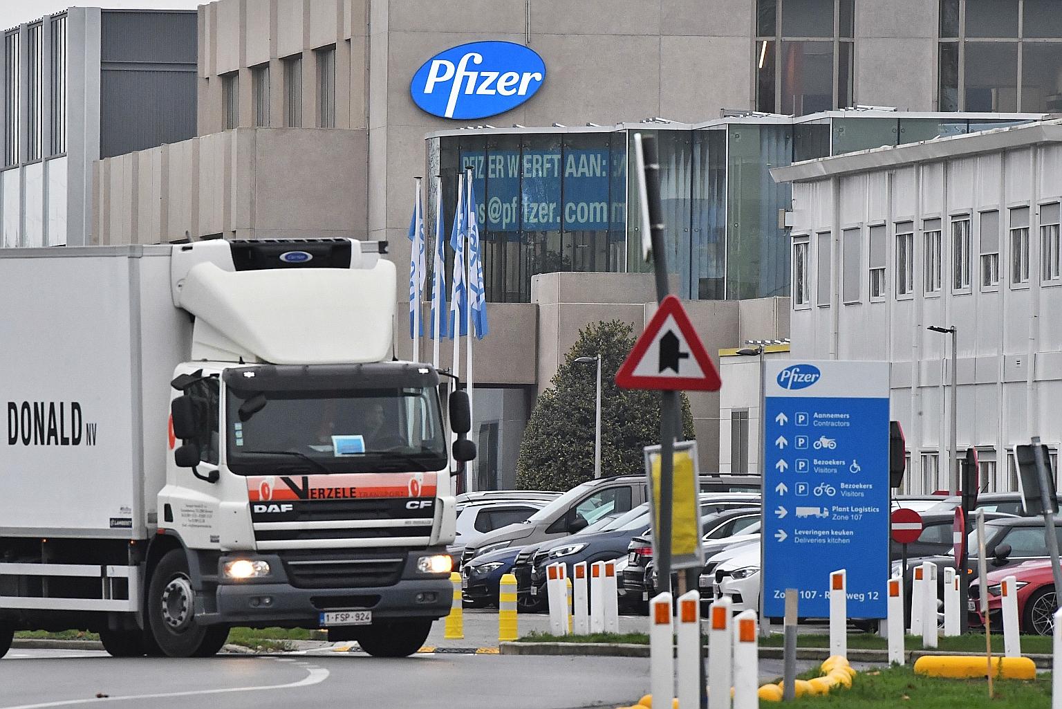 A temperature-controlled truck leaving the Pfizer production plant in Puurs, Belgium, yesterday. The US pharmaceutical giant plans to ship an initial 800,000 doses to Britain in the coming days from its Puurs facility so that they will be ready to be