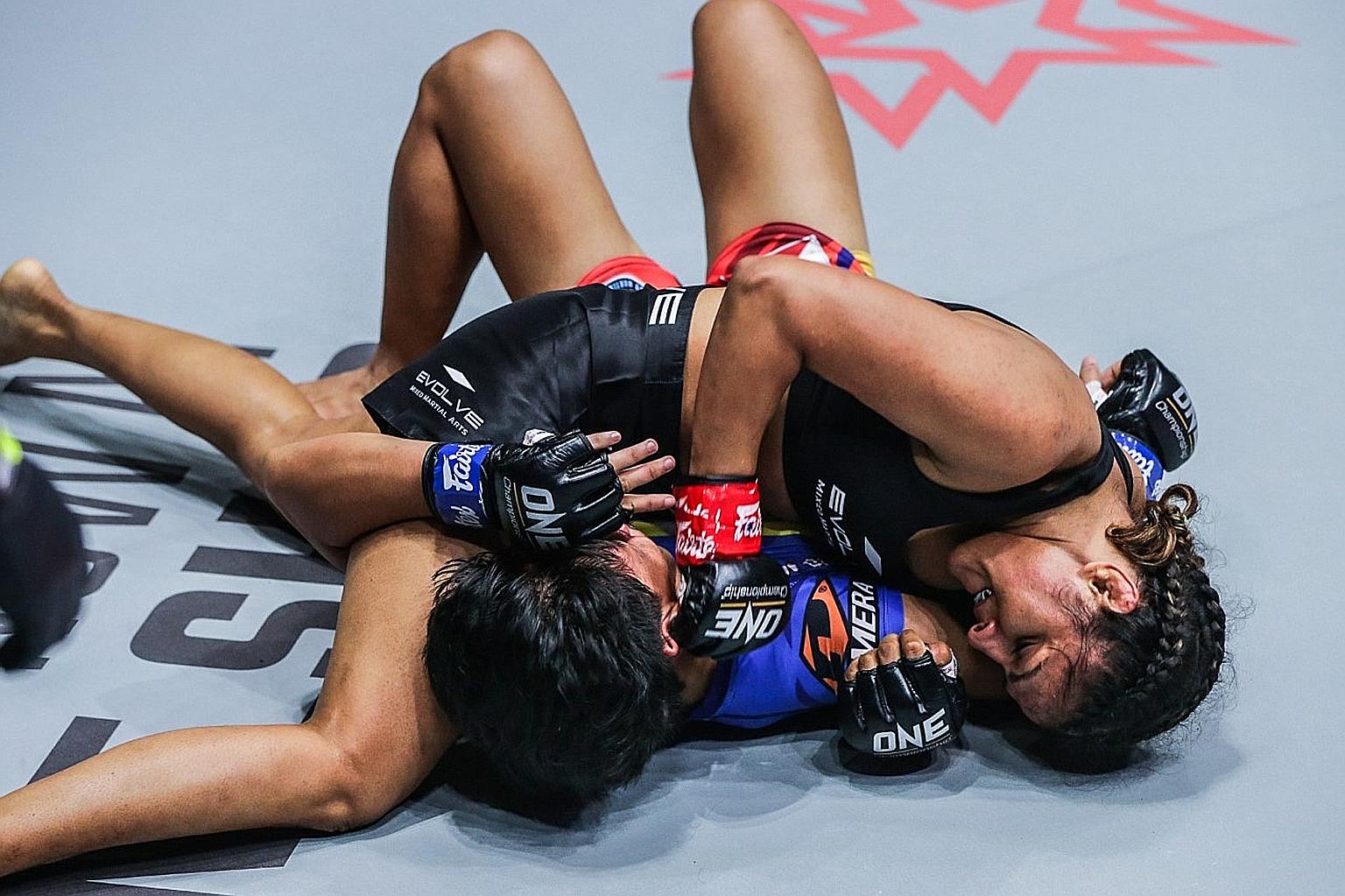 India's Ritu Phogat defeating Jomary Torres via technical knockout in the first round of their One: Big Bang atomweight mixed martial arts bout at the Singapore Indoor Stadium yesterday.