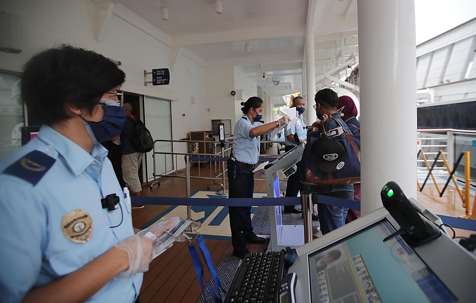 Passengers arriving at Marina Bay Cruise Centre, before they boarded Royal Caribbean's Quantum of the Seas last Thursday for a four-night getaway. The cruise operator says demand for its cruises from next month to March is already building up, with J