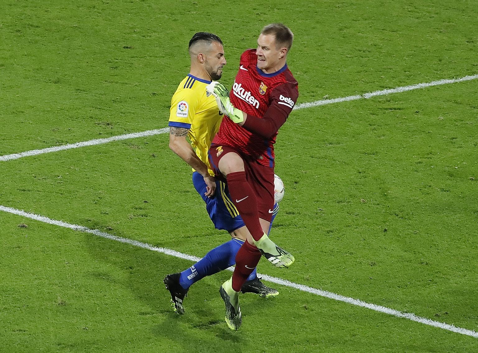 Cadiz's Alvaro Negredo (left) scoring the winner past Marc-Andre ter Stegen after the Barcelona goalkeeper kicked the loose ball against him. The Catalans' coach Ronald Koeman called the chain of mix-ups "an incredible error".
