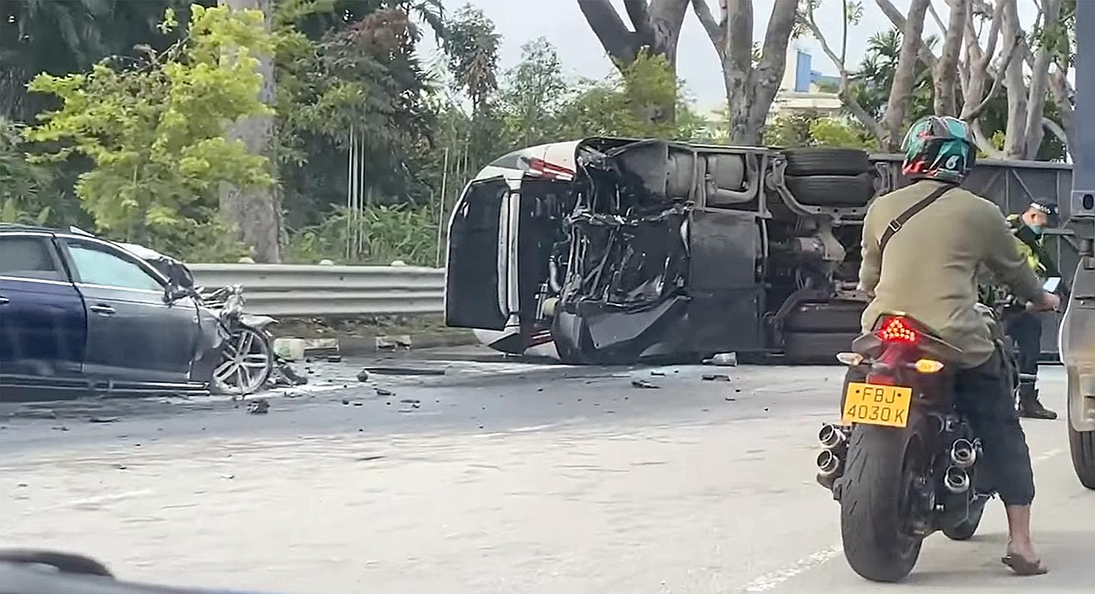 A video screengrab showing a car crushed and a bus lying on its side following their collision yesterday morning on Jurong Island. The driver of the car as well as 21 passengers on the bus were taken to hospital.