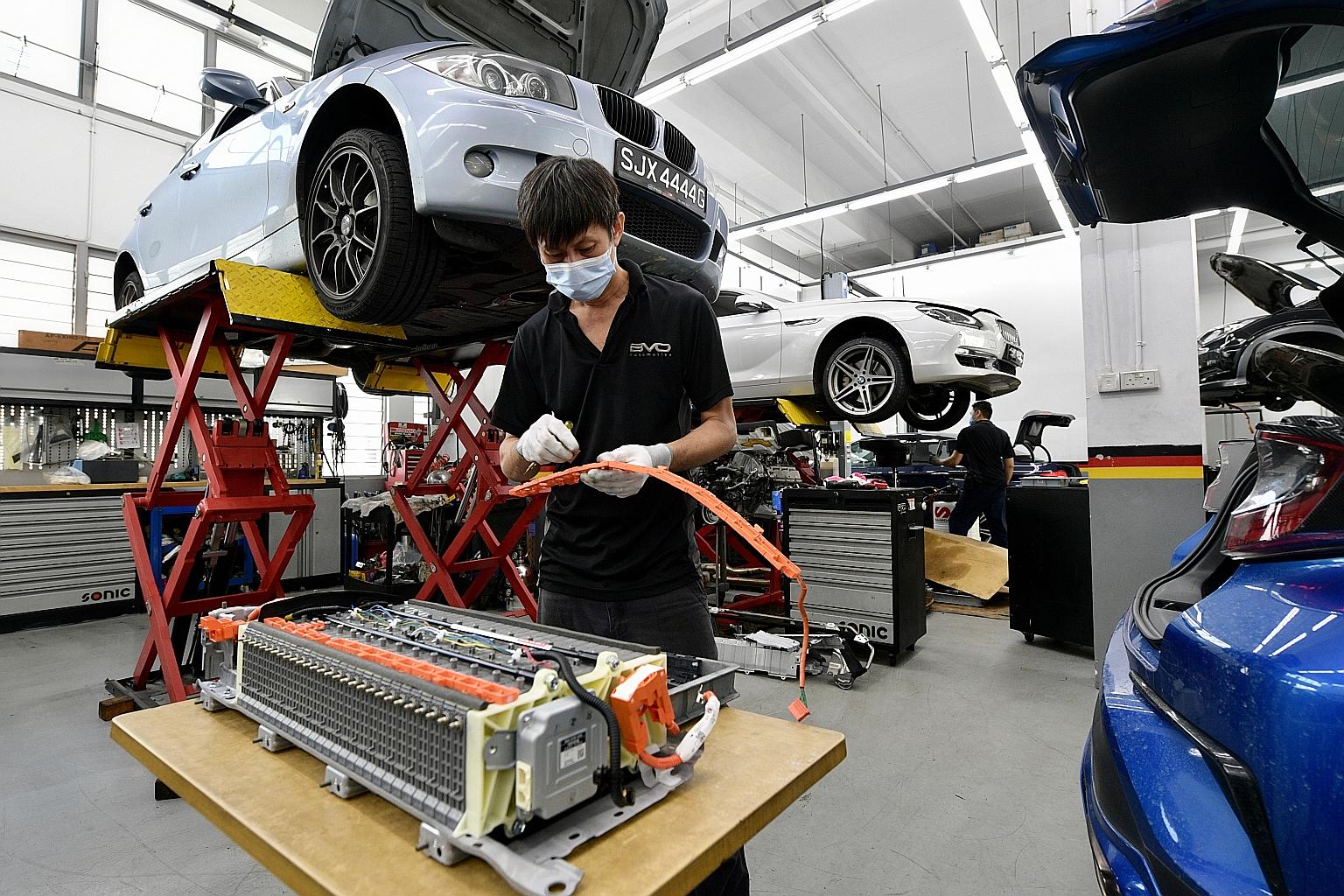 BVO Automative technician Jayden Soh working on a battery for hybrid cars at the company's workshop.