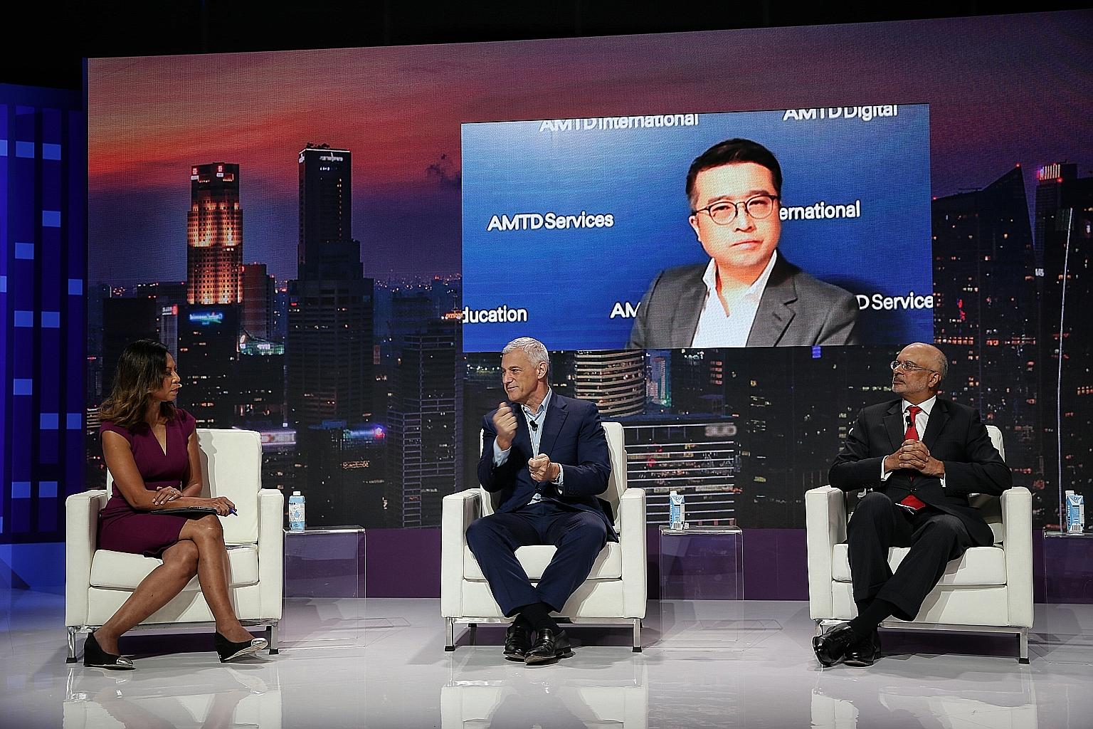 (From left) Moderator Haslinda Amin hosting a panel discussion with Standard Chartered Bank group chief executive Bill Winters, AMTD Group chairman and CEO Calvin Choi (on screen) and DBS Group chief executive Piyush Gupta at the Singapore FinTech Fe