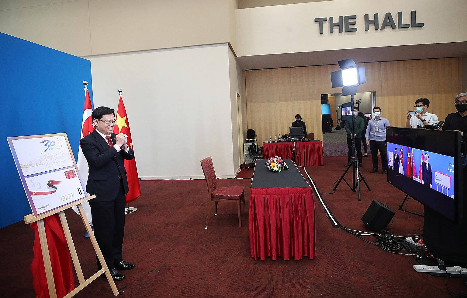 Deputy Prime Minister Heng Swee Keat greeting Chinese Vice-Premier Han Zheng on camera at the 16th Joint Council for Bilateral Cooperation (JCBC) yesterday. The two leaders jointly chair the JCBC, the highest-level bilateral platform between Singapor