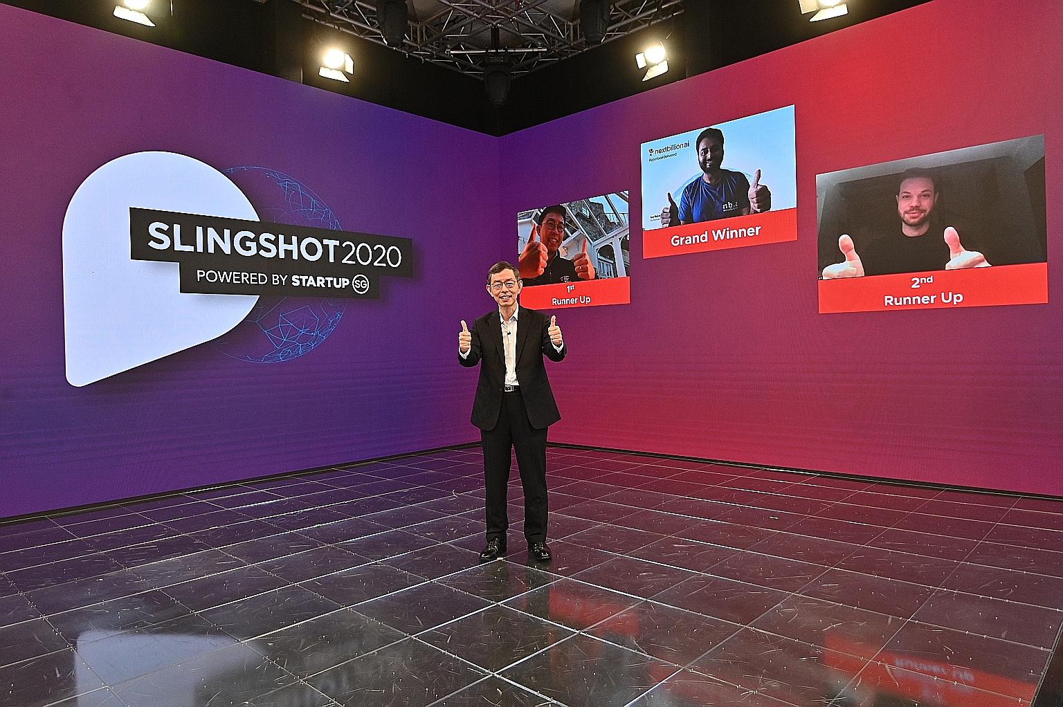 Enterprise Singapore chairman Peter Ong (foreground) with Slingshot winners (from left) GyroGear founder Faii Ong, NextBillion.ai co-founder Ajay Bulusu and Keyless Technologies co-founder Fabian Eberle.