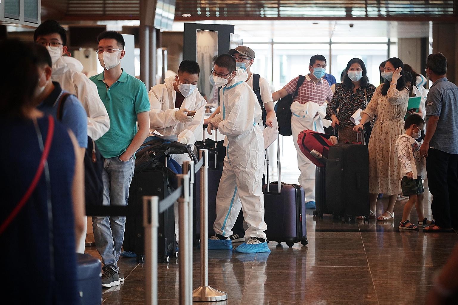 Travellers waiting to check in for a flight at Changi Airport in October. Some Singaporeans are keen to get a Covid-19 vaccination as soon as possible so they can resume travelling.