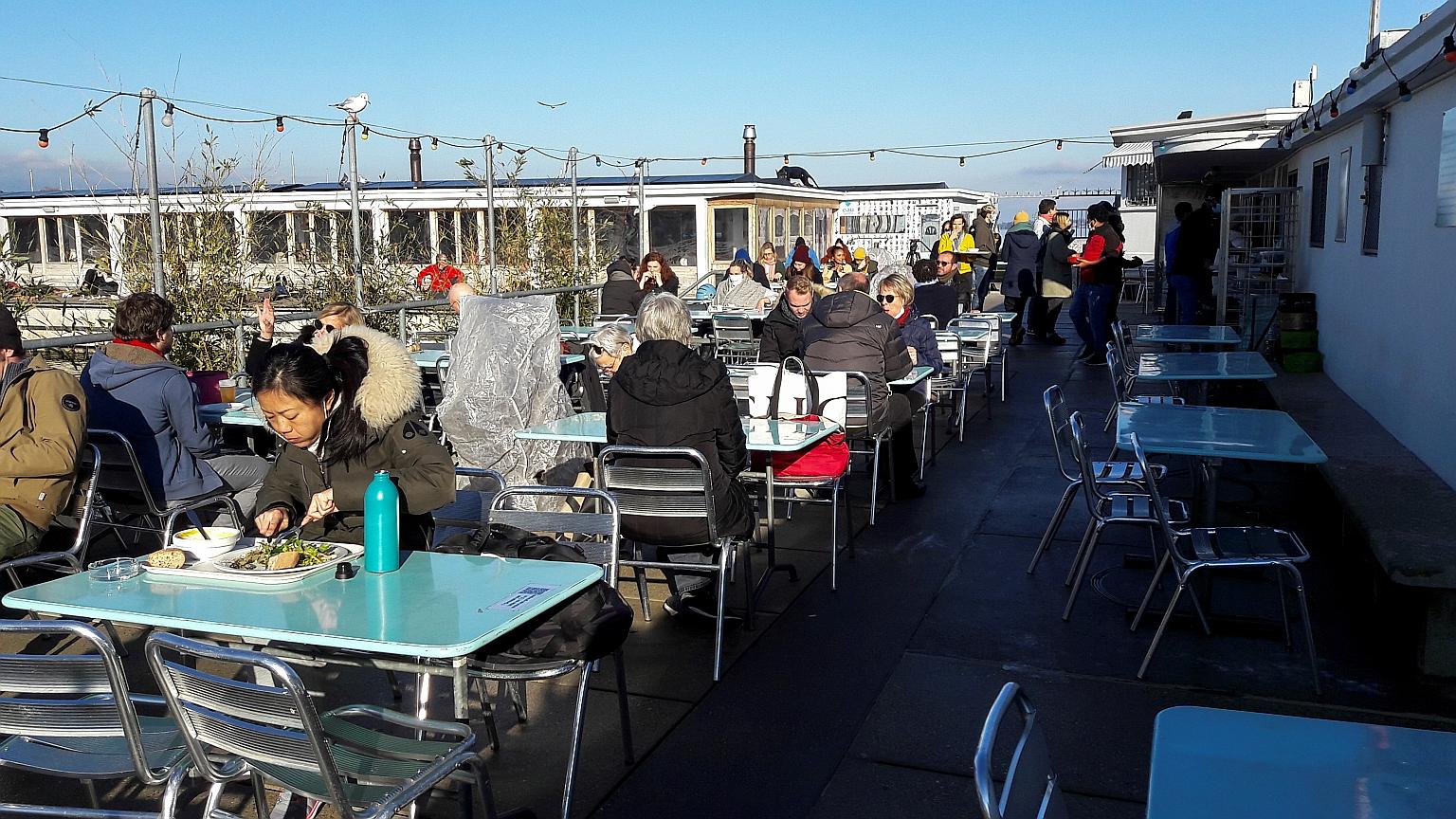 Customers on the terrace of Les Bains des Paquis in Geneva, Switzerland, last week. On Friday, Switzerland announced that all shops, bars and restaurants must close from 7pm in a bid to fight a resurgent coronavirus.