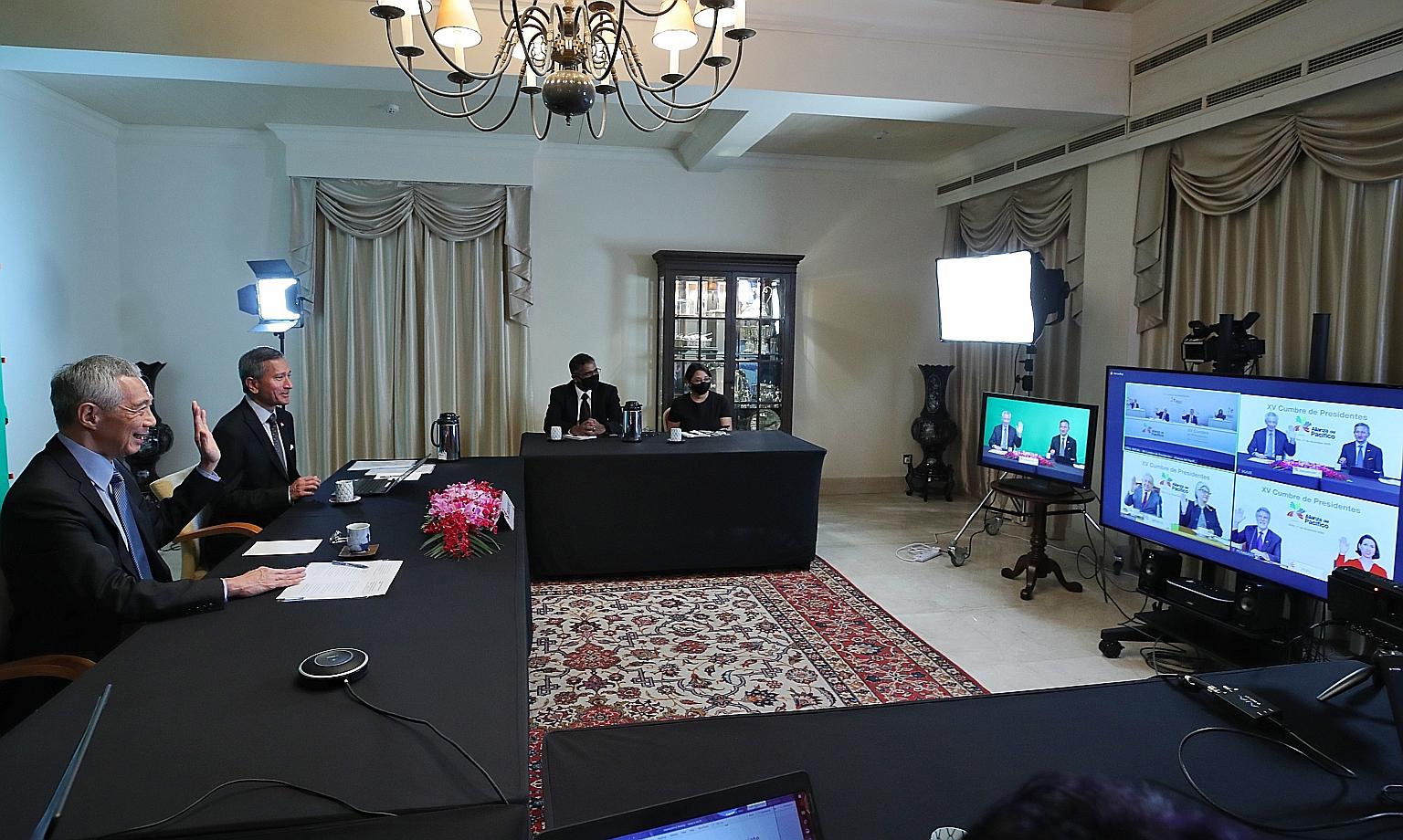 Prime Minister Lee Hsien Loong and Foreign Minister Vivian Balakrishnan attending the Pacific Alliance Summit via video call with the leaders of Chile, Colombia, Mexico and Peru on Friday. PHOTO: MINISTRY OF COMMUNICATIONS AND INFORMATION