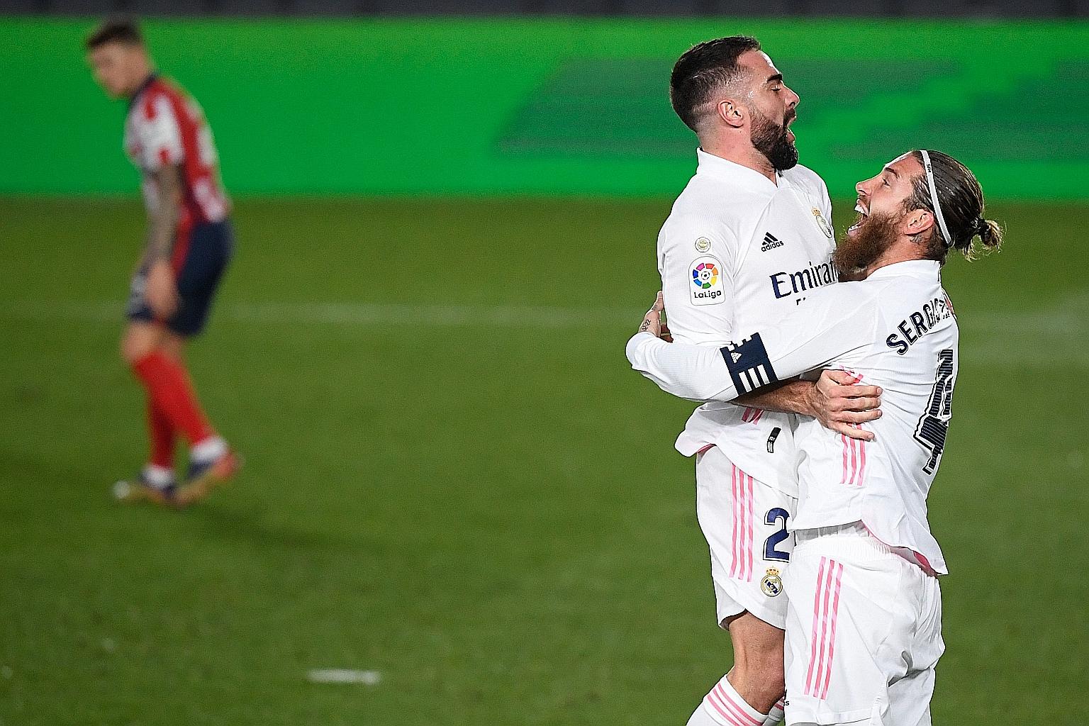 Real Madrid defenders Dani Carvajal and Sergio Ramos celebrating Atletico Madrid goalkeeper Jan Oblak's own goal in the 63rd minute. Real midfielder Casemiro gave the hosts the lead inside 15 minutes.