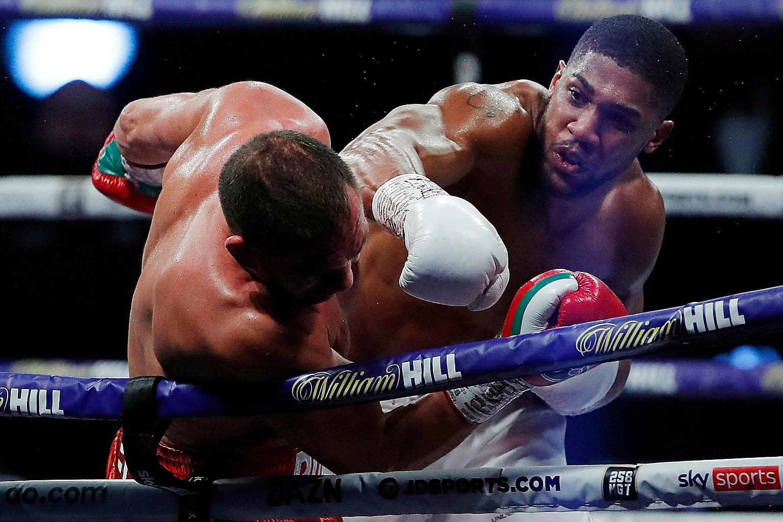 Anthony Joshua landing a punch on Bulgaria's Kubrat Pulev during their heavyweight world title boxing match at Wembley Arena on Saturday. The Briton knocked out his opponent in the ninth round with three quick uppercuts.