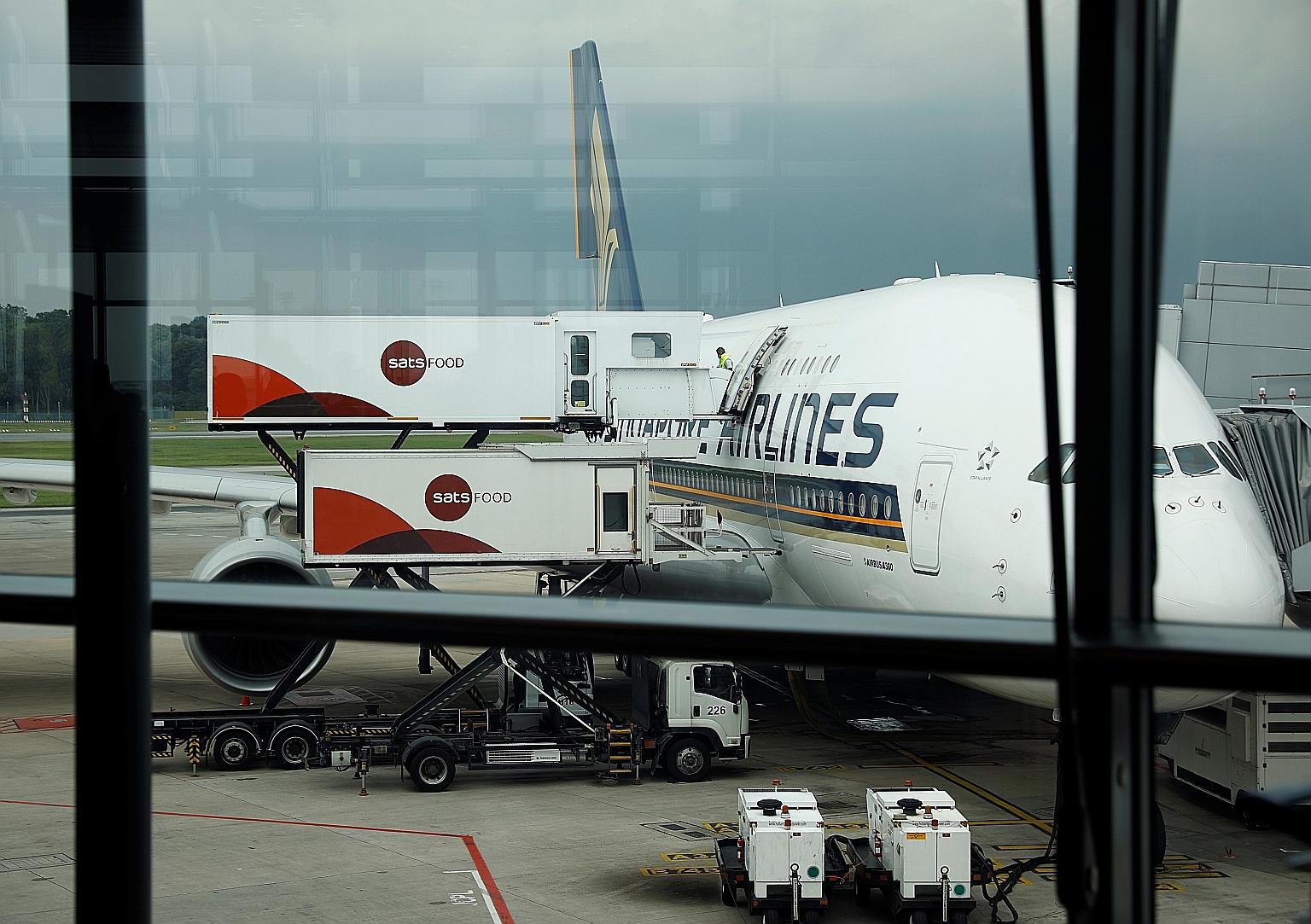 Ground-handler and in-flight caterer Sats restocking a Singapore Airlines plane at Changi Airport in October. The firm was placed first among 100 Singapore publicly listed companies in the 2019 Asean Corporate Governance Scorecard, followed by United