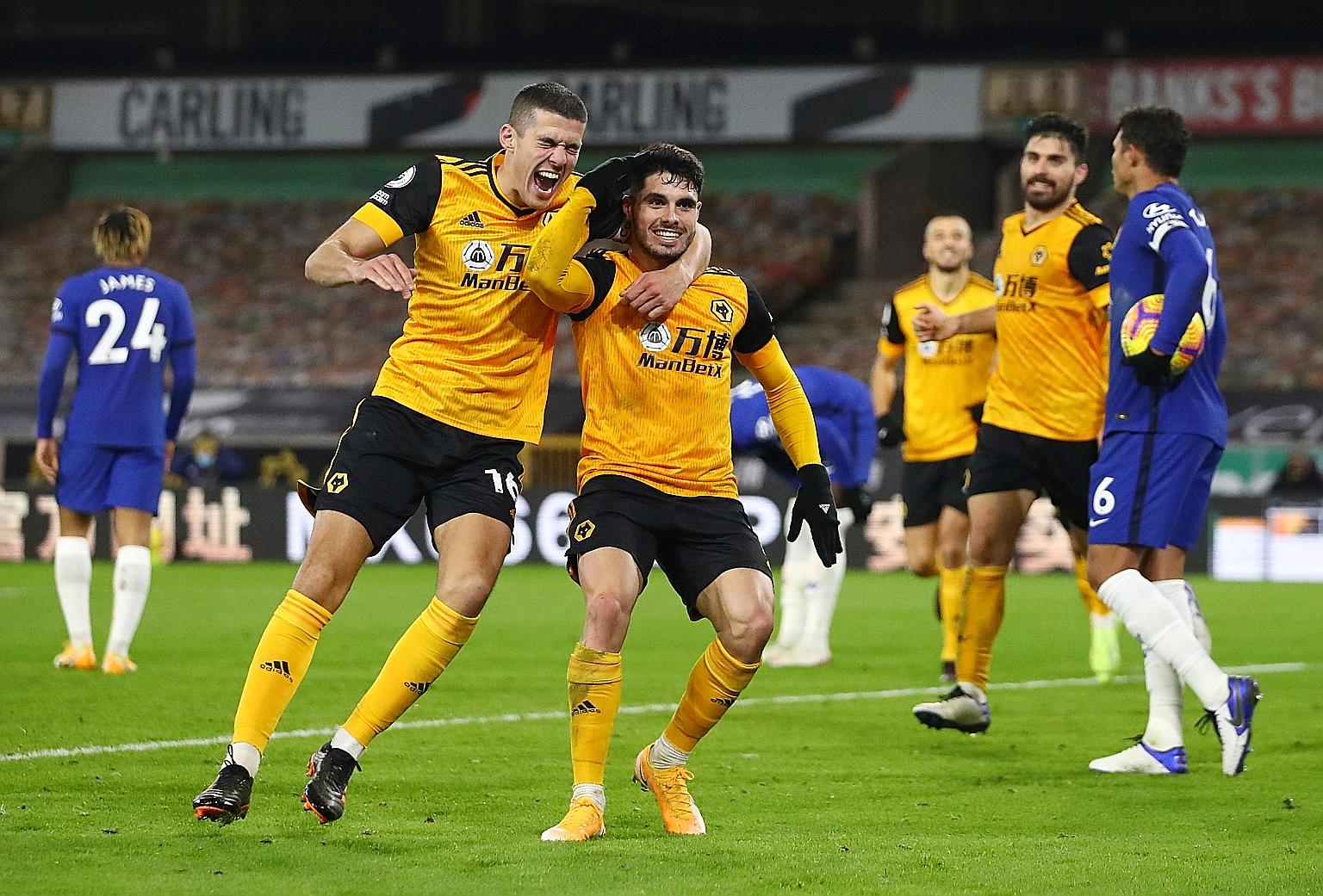 Pedro Neto (right) is joined by an ecstatic Conor Coady in celebrating his breakaway goal that put Chelsea to the sword late in the game.