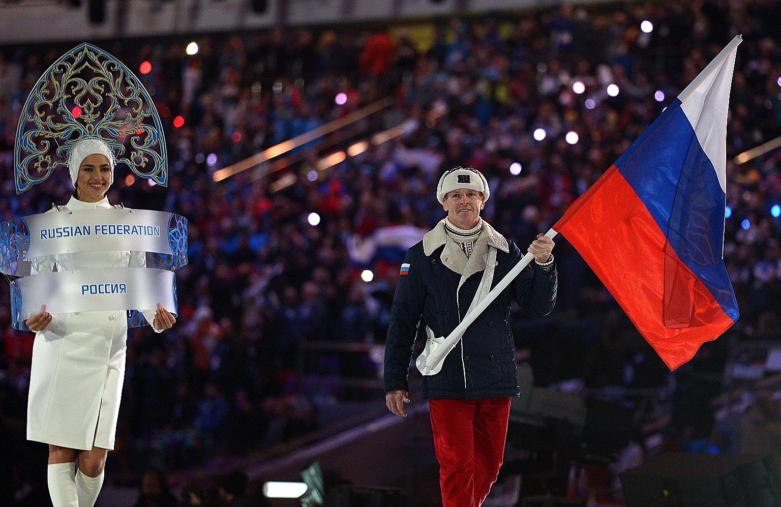 Russian bobsleigher Alexander Zubkov leading the contingent at the opening ceremony of the 2014 Sochi Winter Olympics. Russian athletes will be barred from representing their country at events including next year's Summer Games. But they will be allo