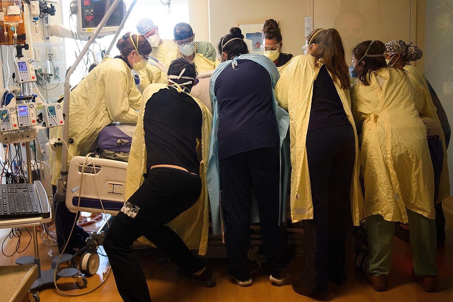 Healthcare staff working on a patient in the Covid-19 intensive care unit at Renown Regional Medical Centre in Reno, Nevada, on Wednesday. Experts now fear the situation in the United States will become even more dire following end-of-year celebratio