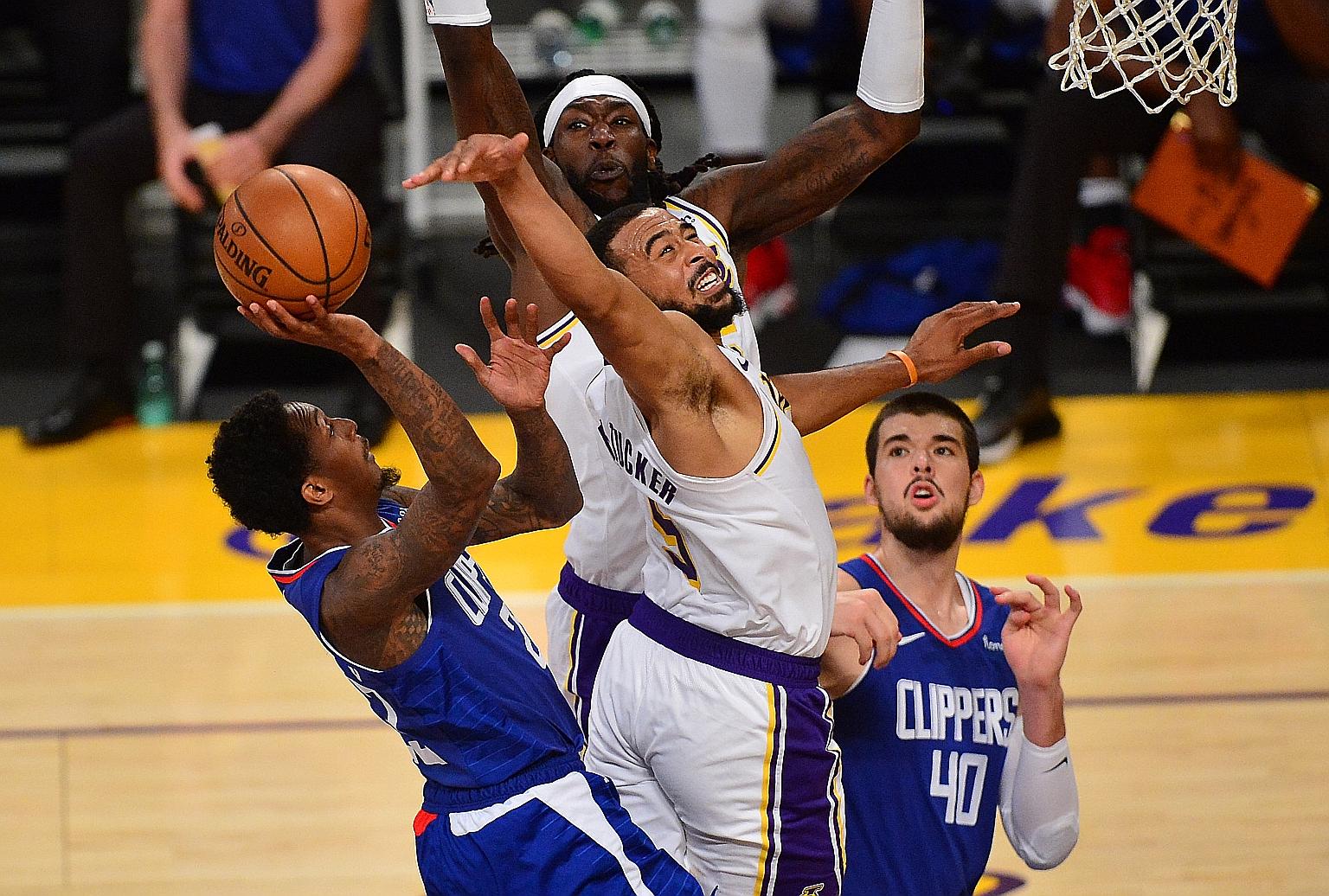 Los Angeles Lakers guard Talen Horton-Tucker defending against Clippers' Lou Williams during the champions' 131-106 pre-season win on Sunday. The city rivals will meet again on Tuesday during their season opener.