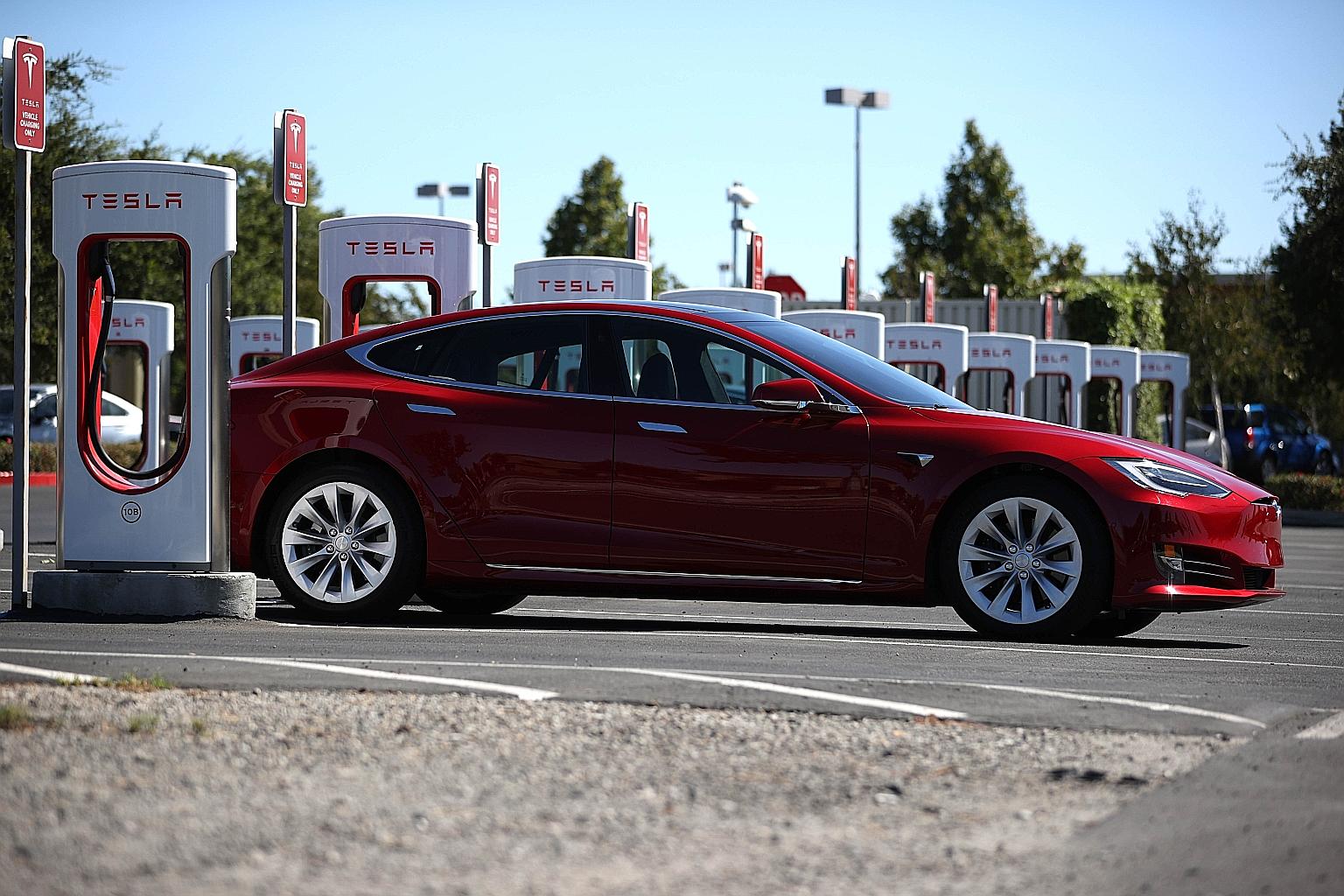 A Tesla electric car at a charging station in California. The company's stock has already seen a spectacular rise this year of 680 per cent, and with a market capitalisation of about US$600 billion (S$796 billion), it will be the richest company to e