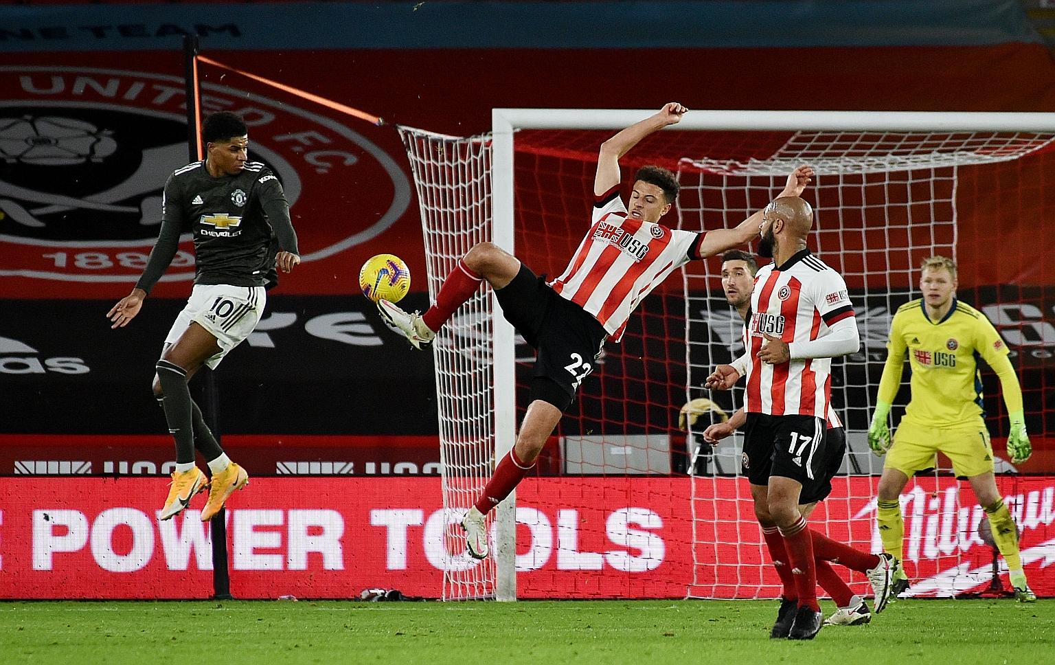 Manchester United forward Marcus Rashford (left) proving to be a thorn in Sheffield United's defence during their Premier League match at Bramall Lane on Thursday. His double in the 3-2 win boosted his tally to five league goals this season, all scor