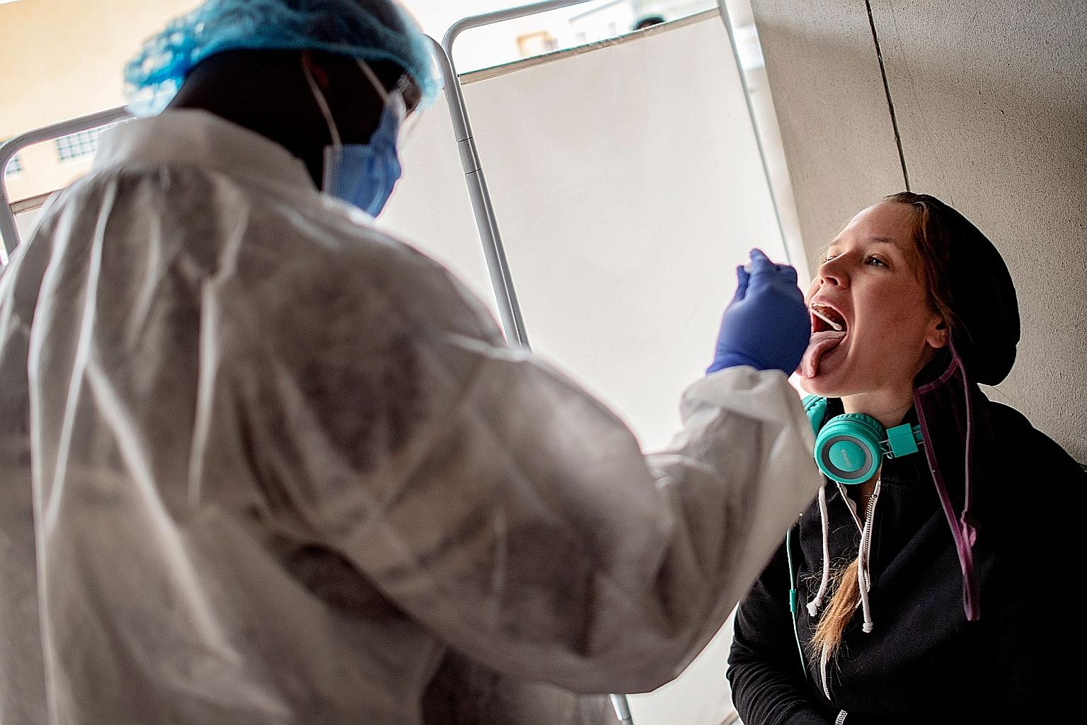 A nurse administering a Covid-19 test at Lancet Nectare hospital in Richmond, Johannesburg, on Friday as the rapid spread of a second wave affects younger people. As of Friday, South Africa had recorded 24,845 deaths and more than 900,000 cases among