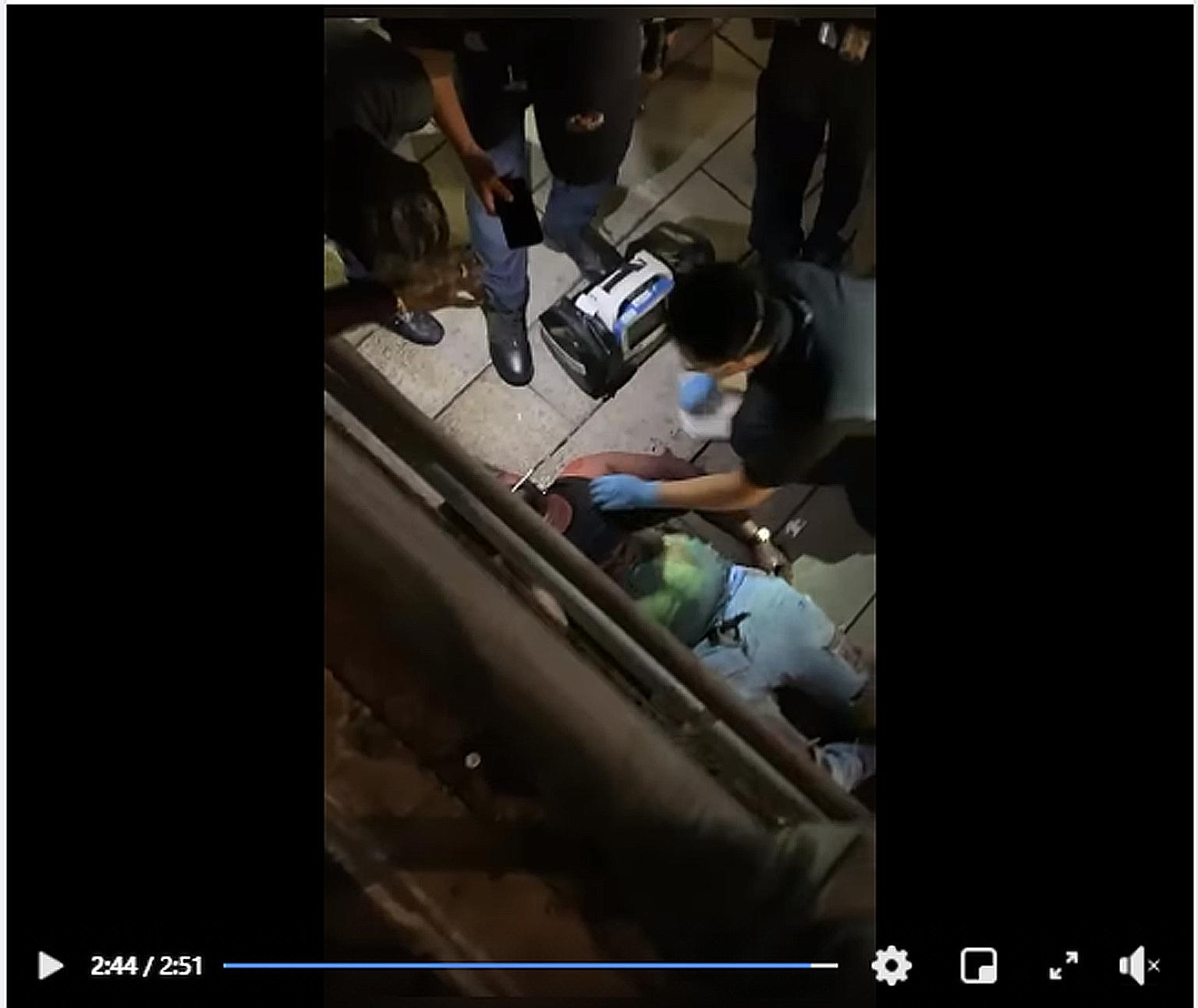 A screengrab of a video of the fight, which shows paramedics tending to a man lying on a walkway leading towards an underpass outside The Central mall in Clarke Quay on Saturday night.