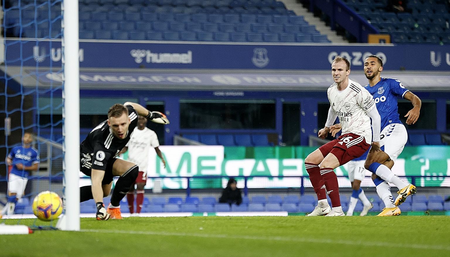 Everton's Dominic Calvert-Lewin looking on as Arsenal's Rob Holding scores an own goal past goalkeeper Bernd Leno at Goodison Park to put the hosts 1-0 up. The Toffees won 2-1.