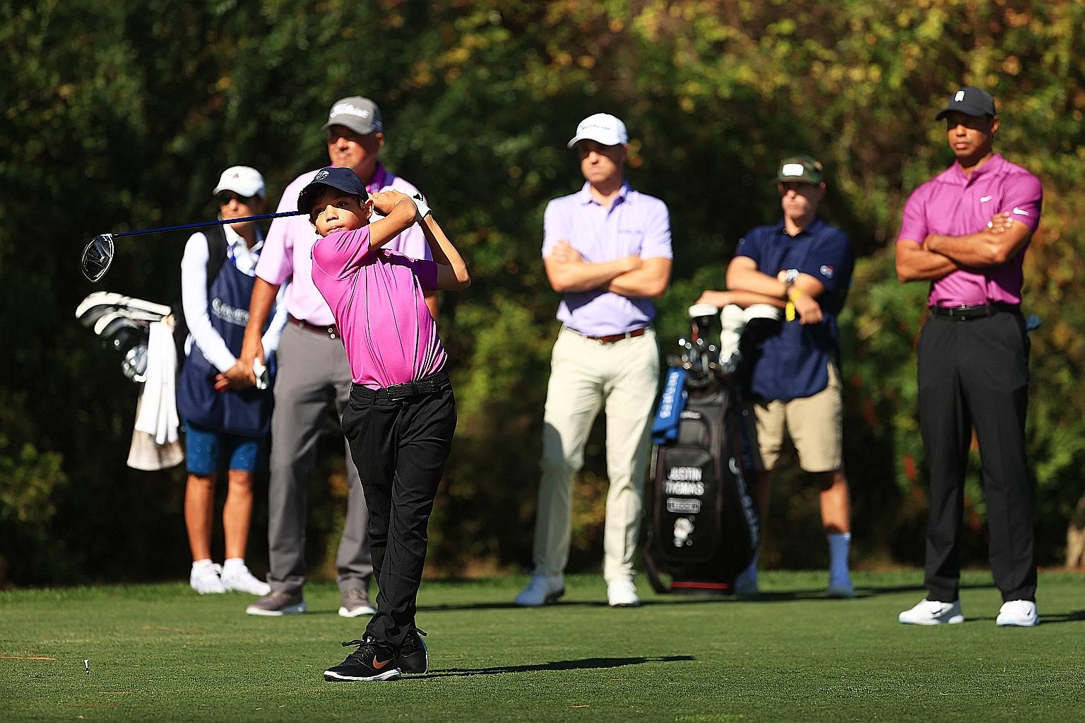 Eleven-year-old Charlie Woods, teeing off during the first round of the PNC Championship at the Ritz-Carlton Golf Club in Orlando, Florida. Observers have noted how his swing resembles that of his father Tiger. PHOTO: AGENCE FRANCE-PRESSE