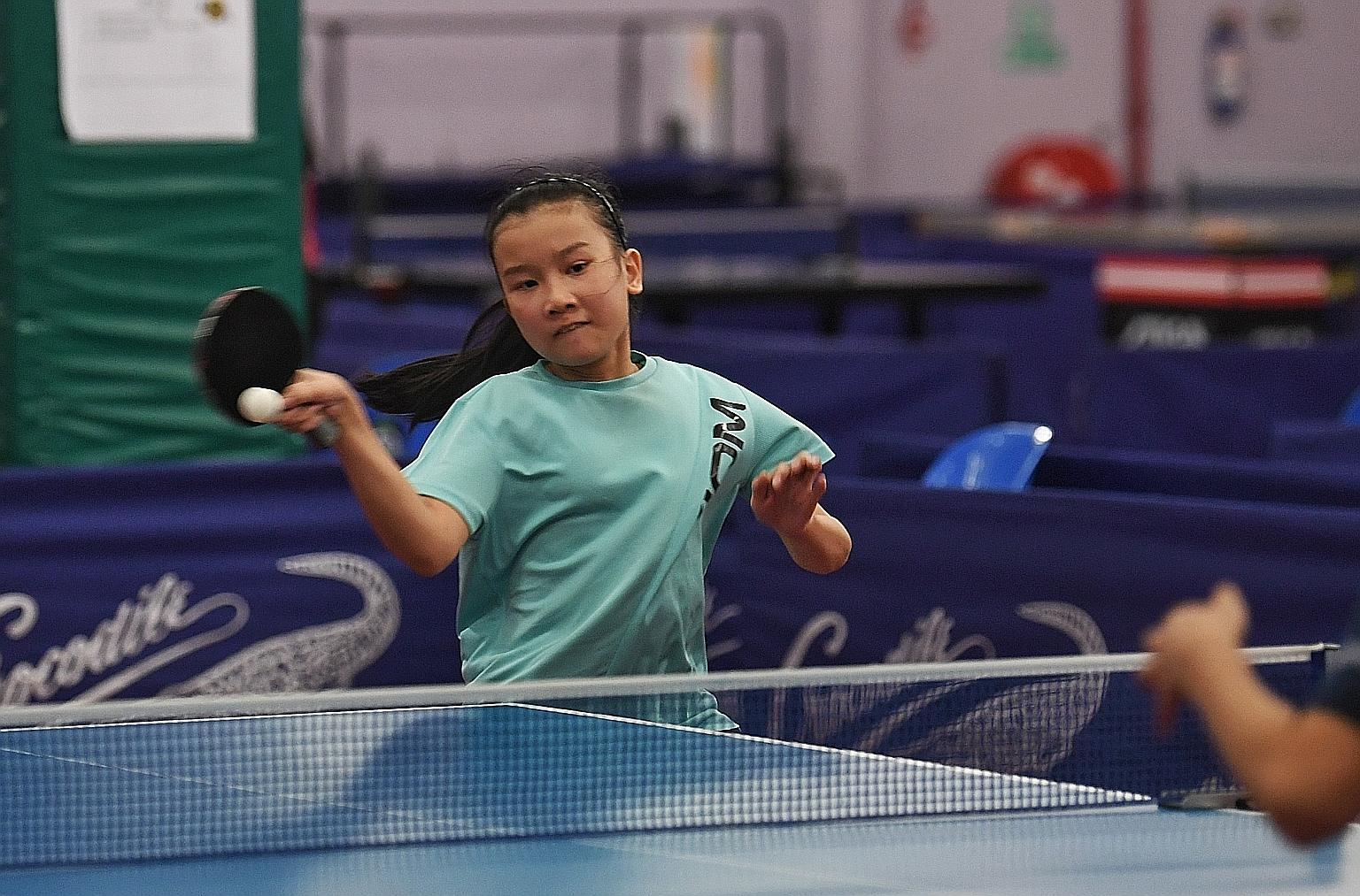 Kong Hwa School's Ang Rae Shyn hitting a forehand against Nan Hua Primary's Eudora Lee. She won 13-15, 11-5, 11-8, 11-8 to take the Crocodile Challenge Cup Primary 5 & 6 girls' singles title. A record 67 schools took part in the first table tennis ev