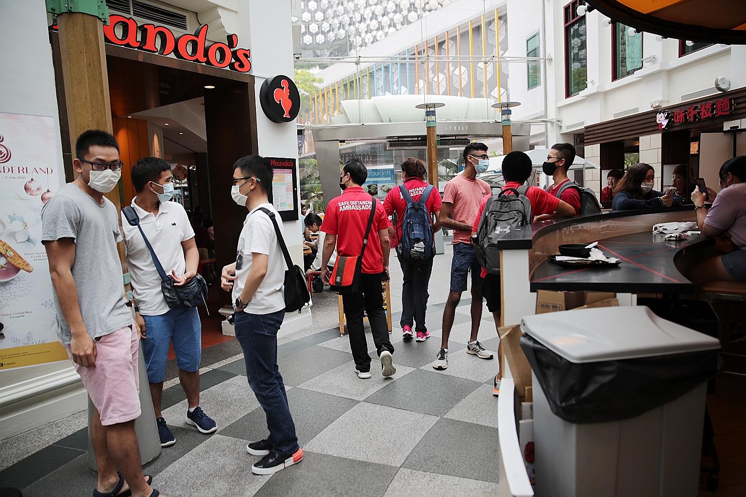 Above: Shoppers at West Mall yesterday, on the final weekend before Christmas. ST PHOTO: CHONG JUN LIANG Right: VivoCity on Saturday, where regular announcements reminded people to keep a safe distance. ST PHOTO: GIN TAY Below: Social distancing amba